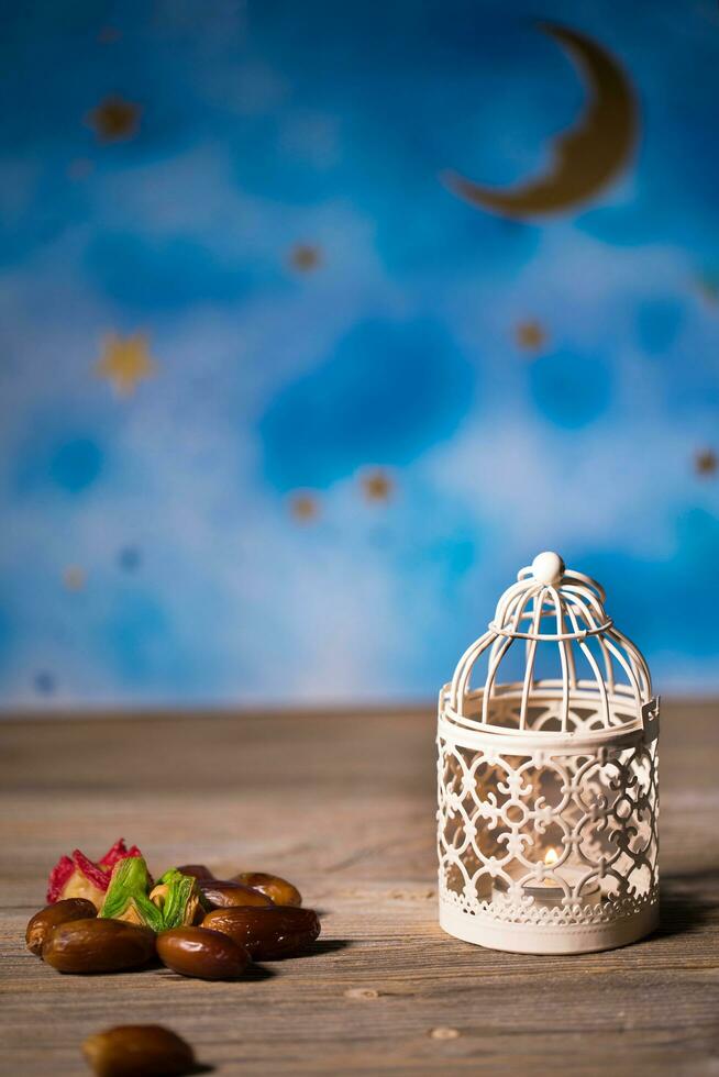 Dates and candle holder on a wooden surface. photo