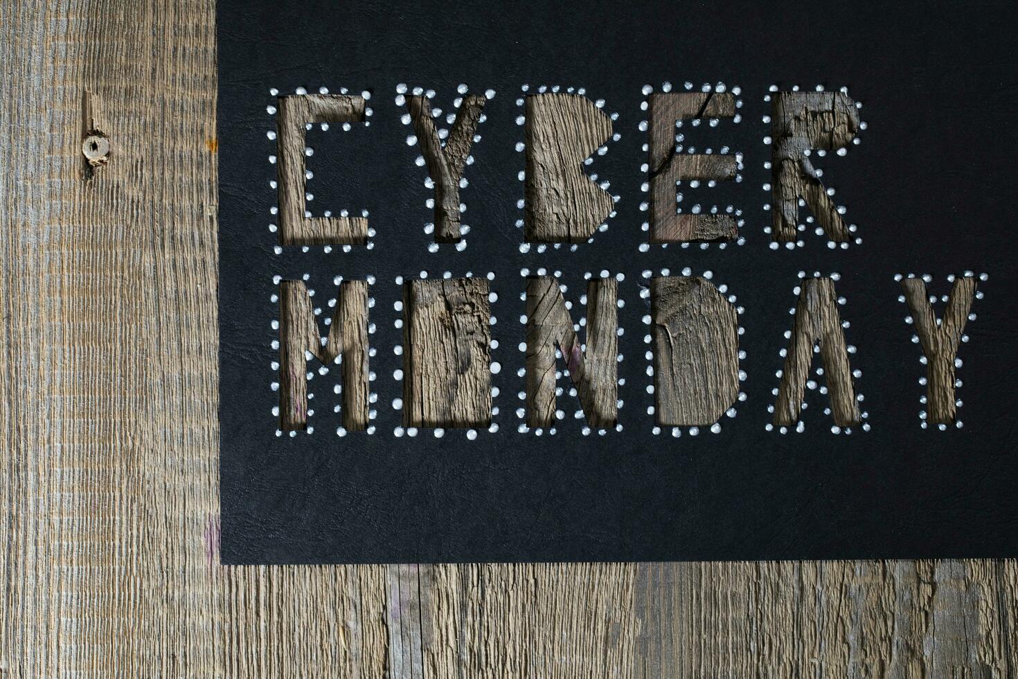 Words CYBER MONDAY on black carton paper photo