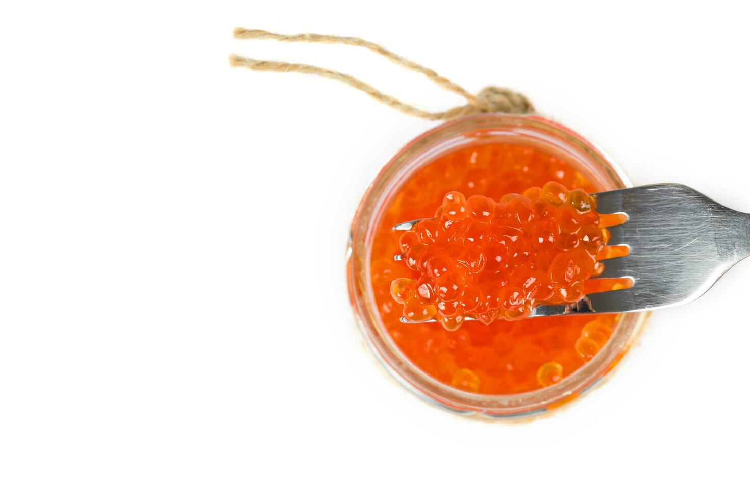 Red caviar on a metal fork. photo