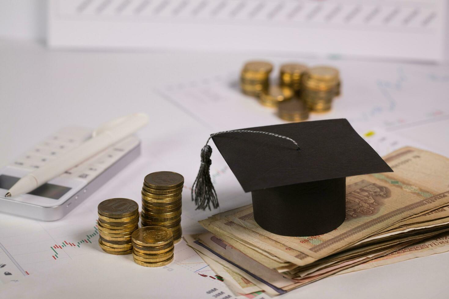 Graduate hat on a pile of banknotes. photo