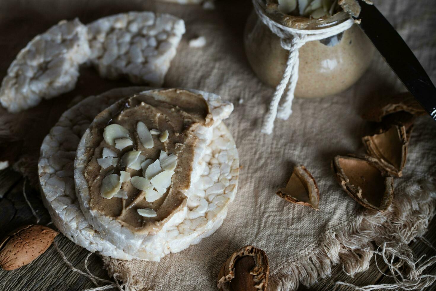 Homemade almond butter on a slice of rice crispbread. photo