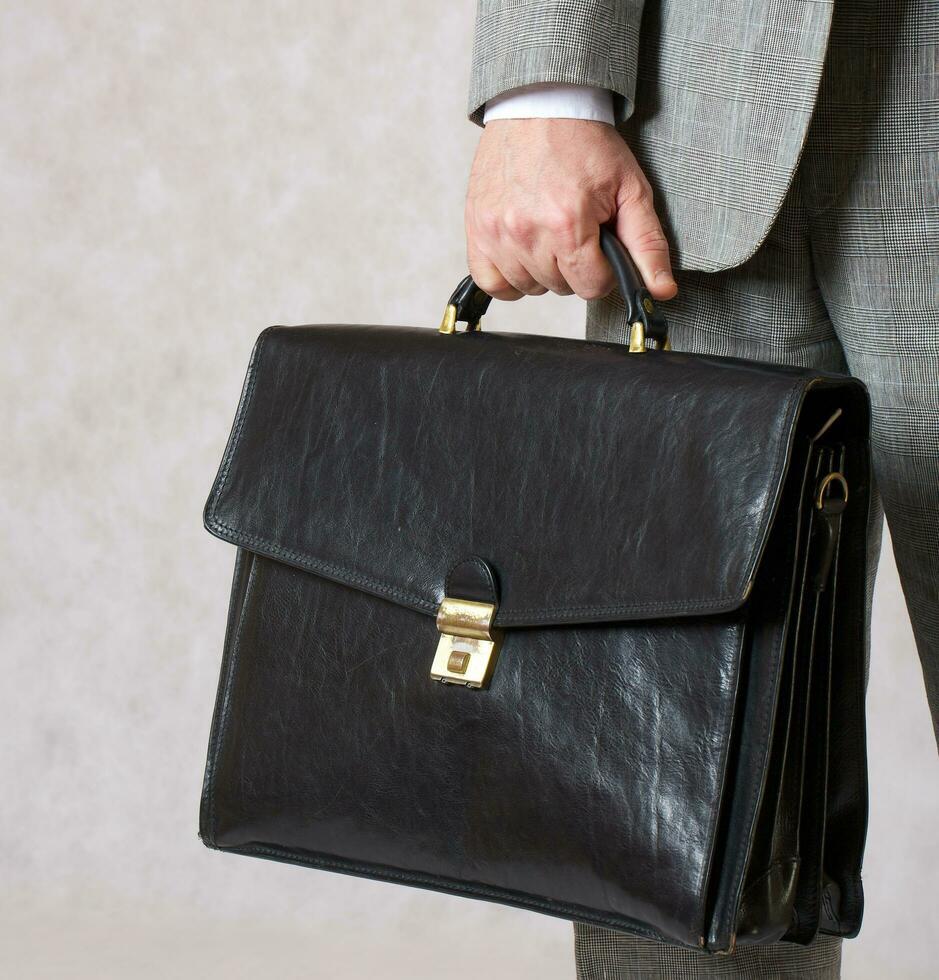 A business keeps his bag. Closeup photo