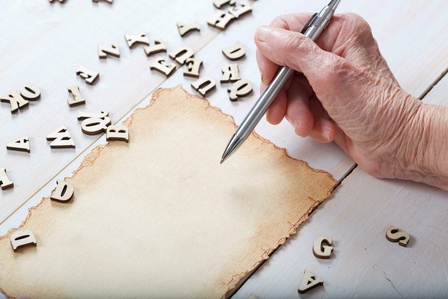 Old woman writes something. photo