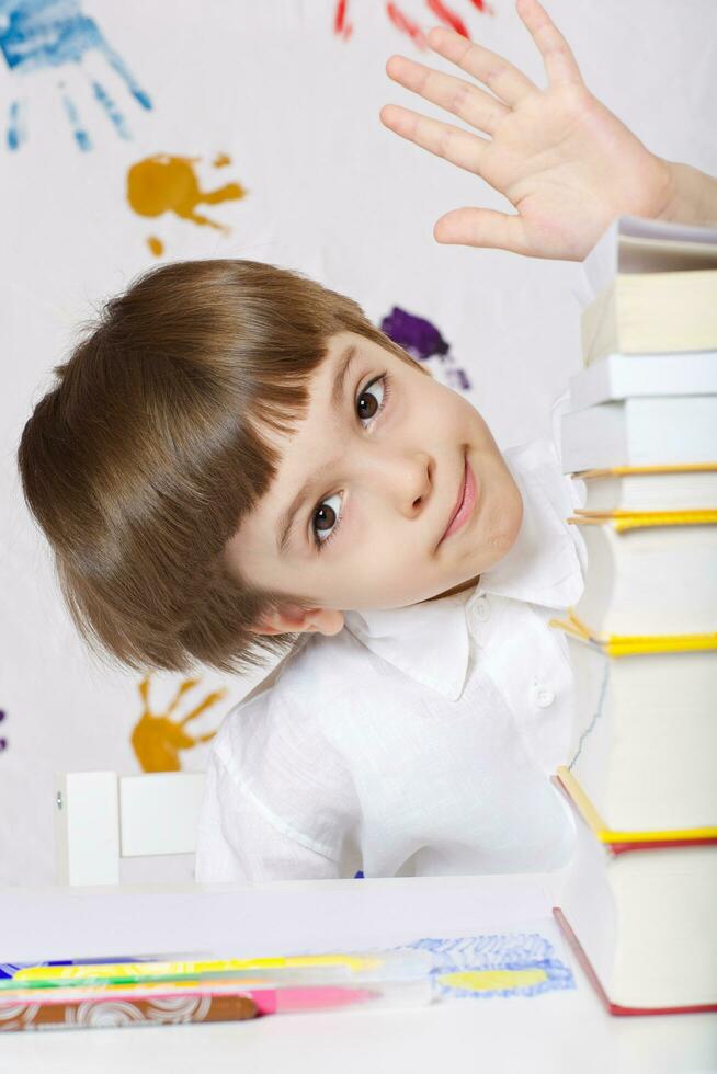 Boy of seven years old with books. Back to school photo