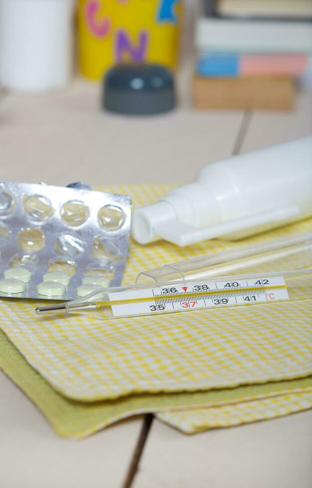 Mercury thermometer on a working table photo