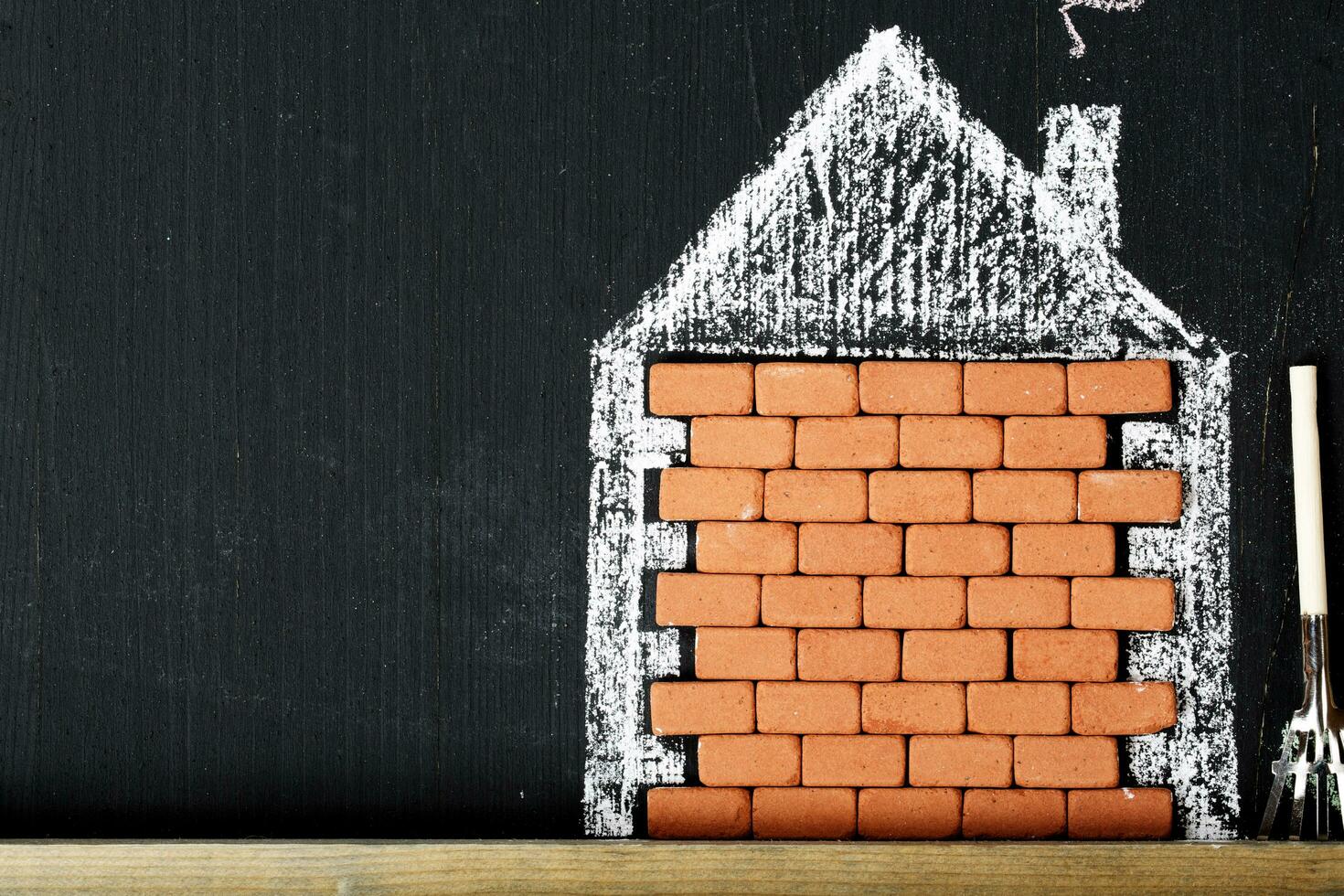 Painted house and the yard in a colourful chalk. Closeup photo