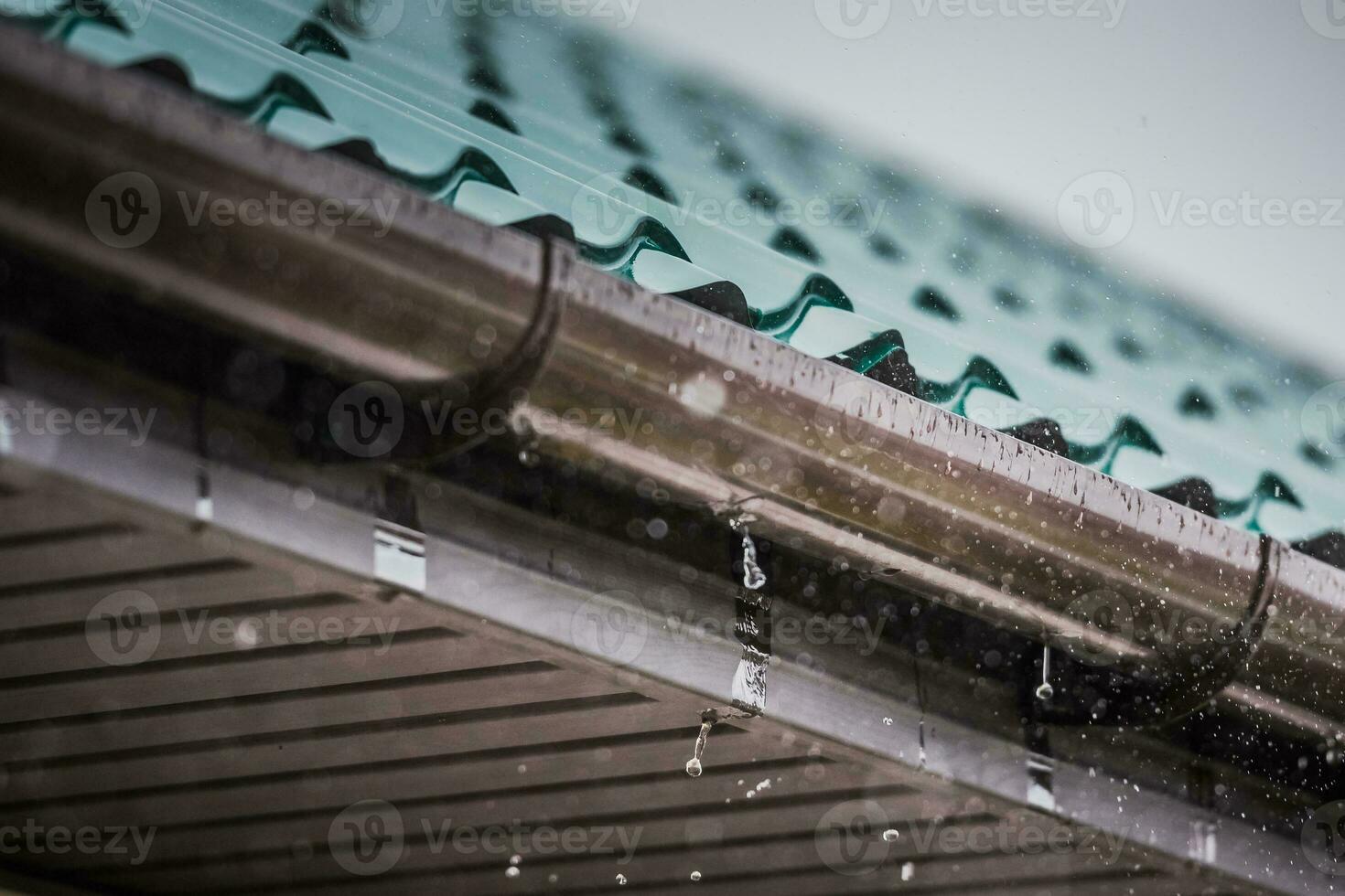 rain flows down from a roof down photo