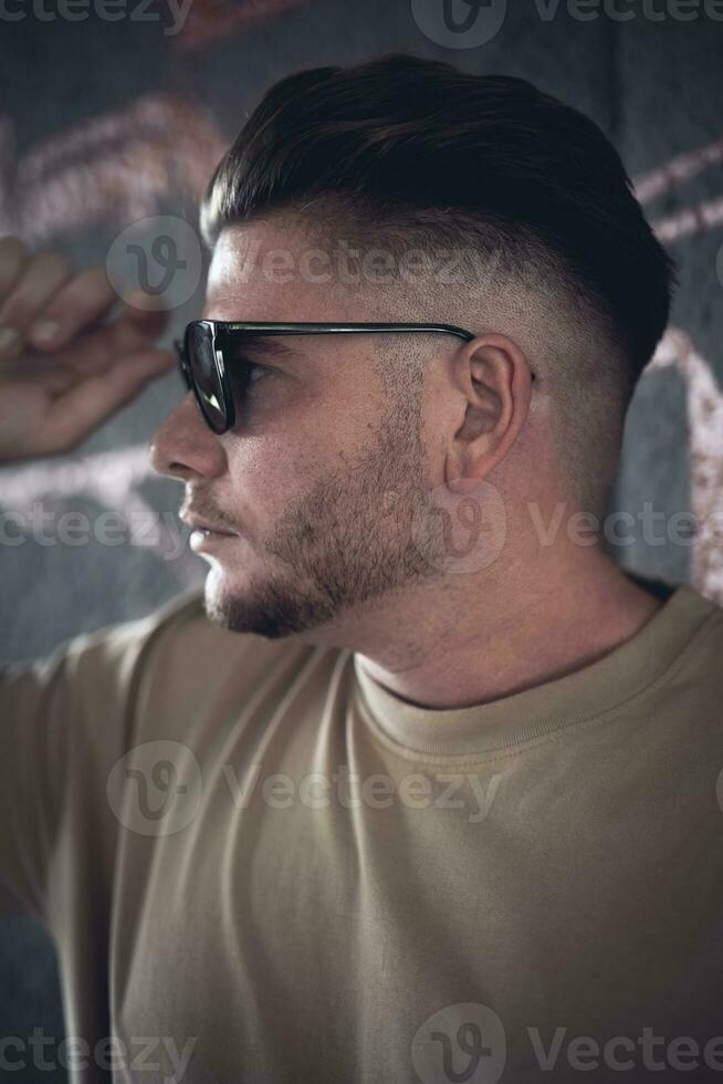 a pretty man portrait with sunglasses photo