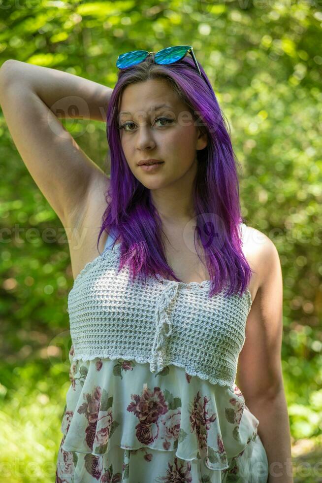 a woman portrait with long purple hair and sunglasses photo