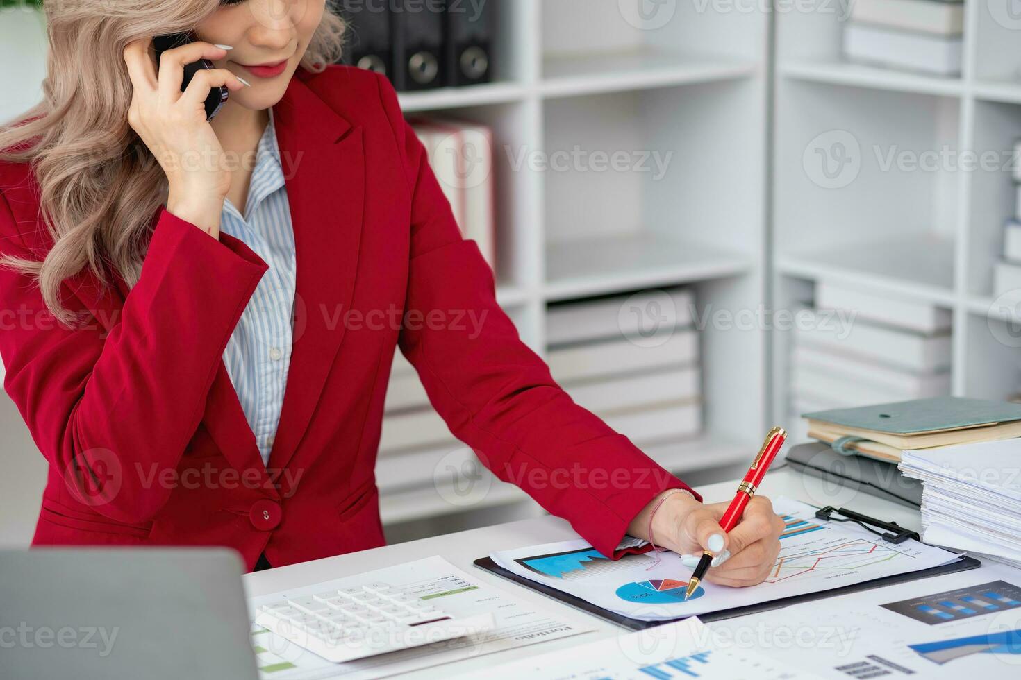 Consultant, Asian businesswoman working on the phone who discussion financial work and marketing business plan to increase company profits, ready to use computer and marketing planning documents. photo