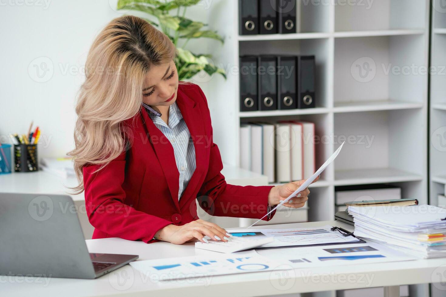 Consultant, Asian businesswoman working on the phone who discussion financial work and marketing business plan to increase company profits, ready to use computer and marketing planning documents. photo