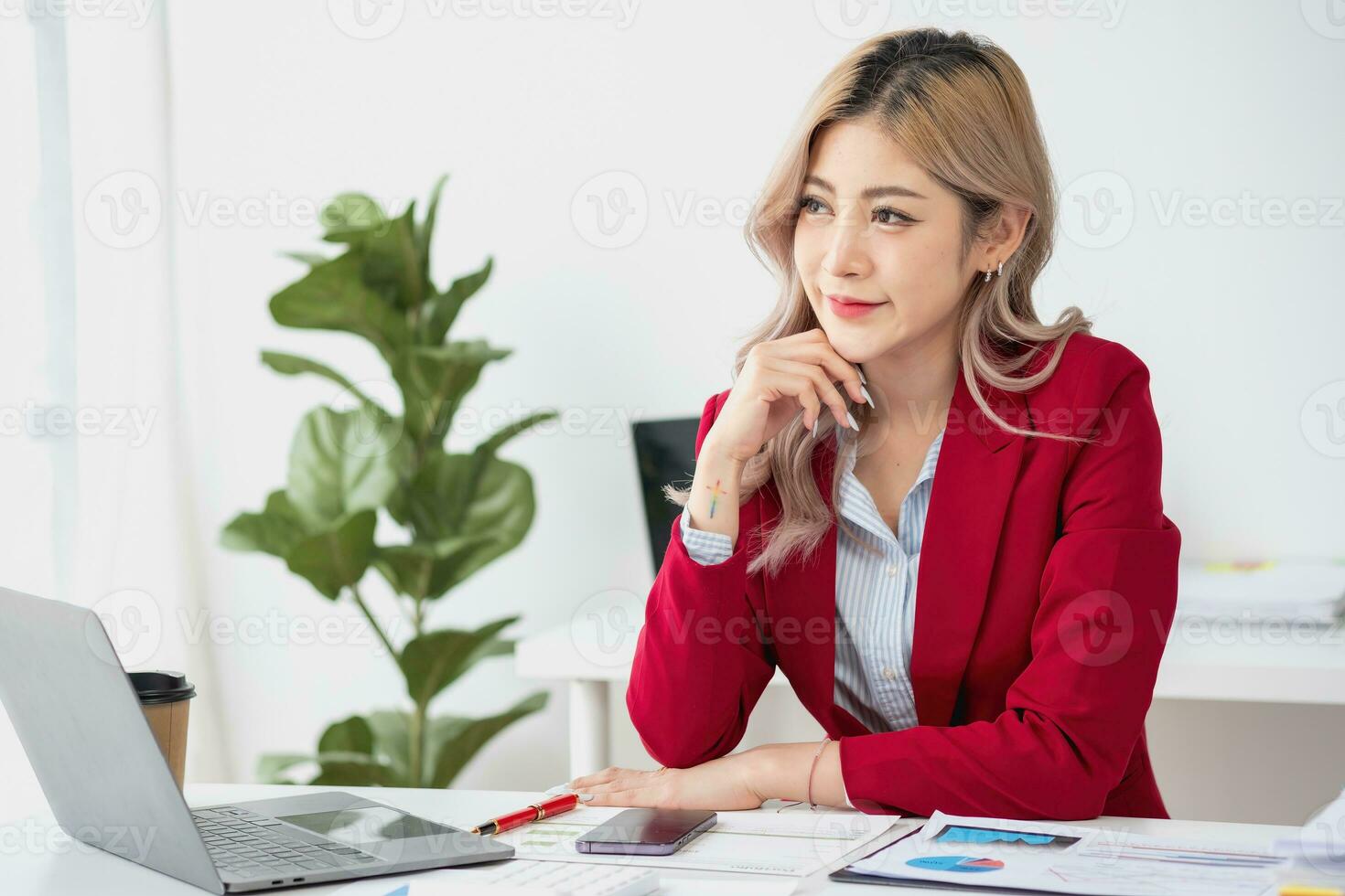 Portrait of a woman business owner showing a happy smiling face as he has successfully invested in her business using tablets and financial budget documents at work. photo