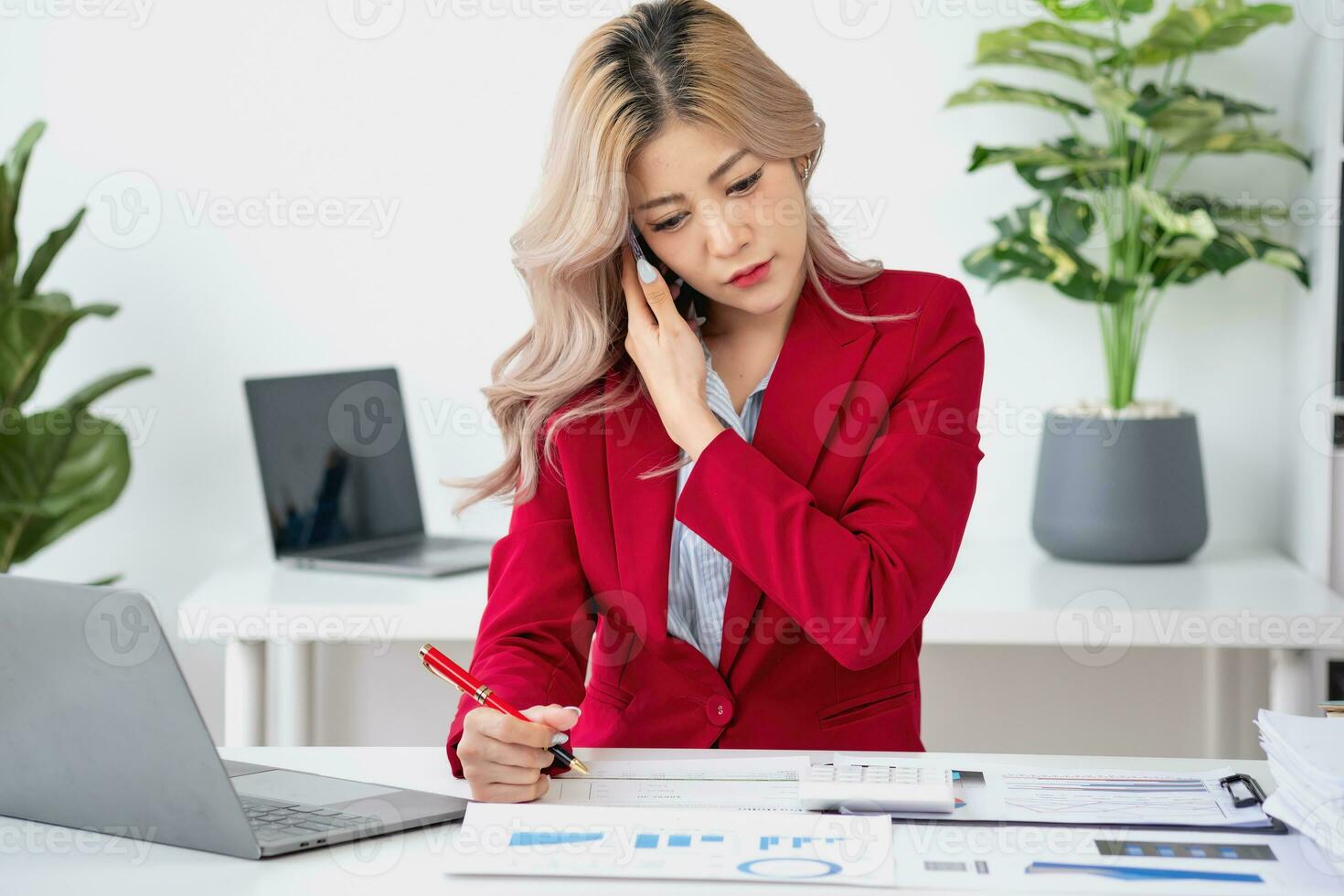 Consultant, Asian businesswoman working on the phone who discussion financial work and marketing business plan to increase company profits, ready to use computer and marketing planning documents. photo