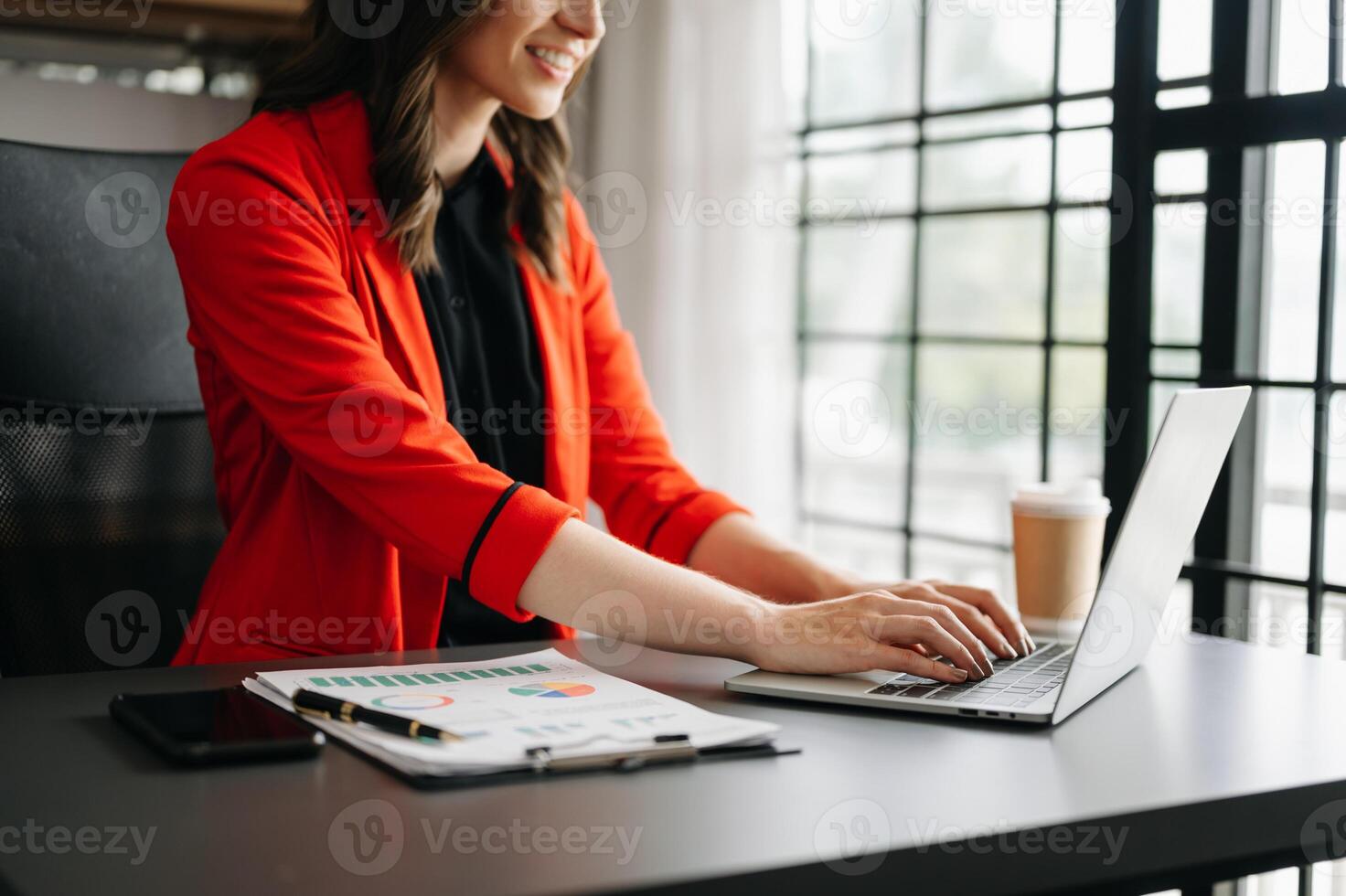 business documents on office table with smart phone and digital tablet and graph financial and woman working at office photo