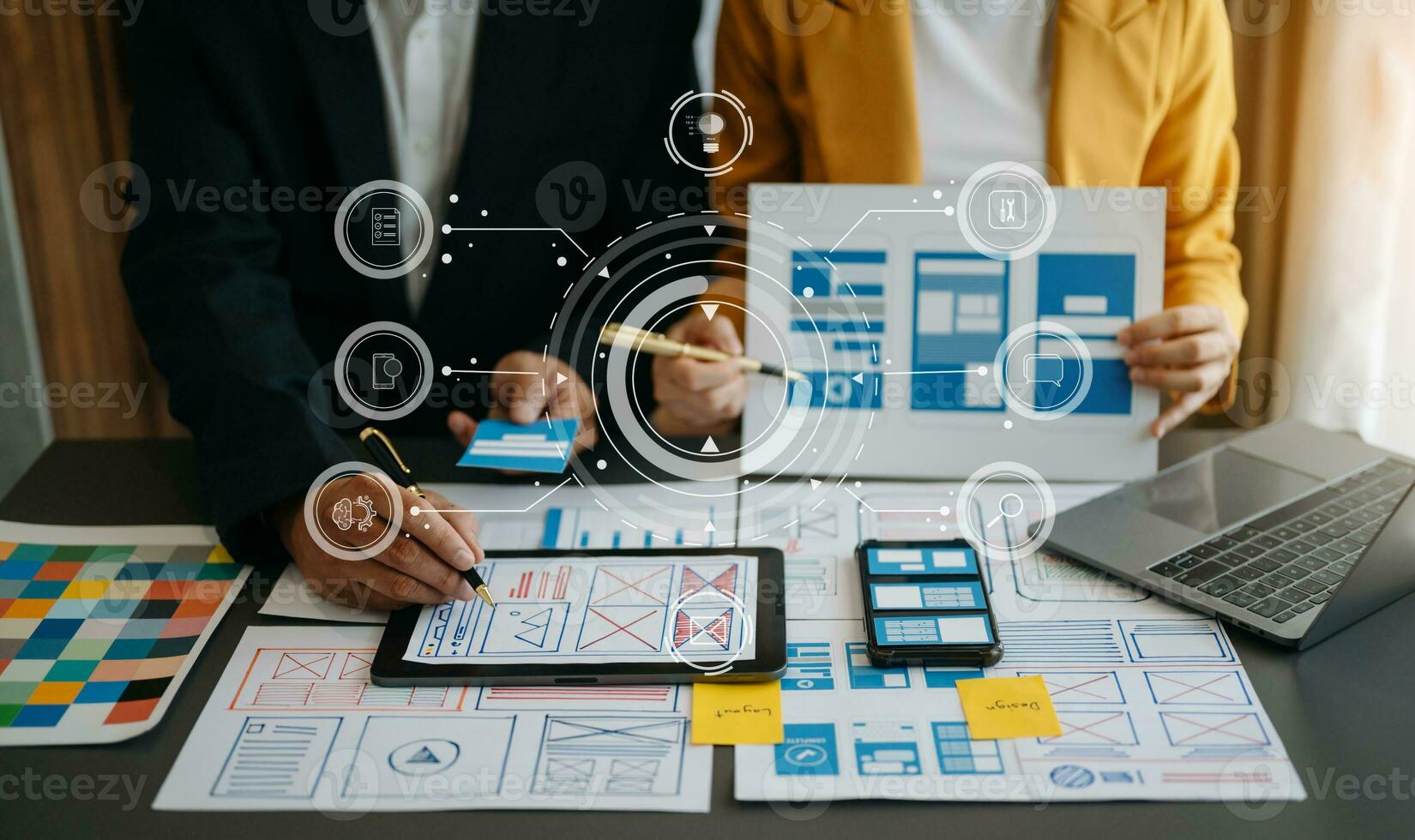 Close up view of UI developer team brainstorming on their project with laptop, smartphone and digital tablet. Creative digital development agency. with virtual icons photo