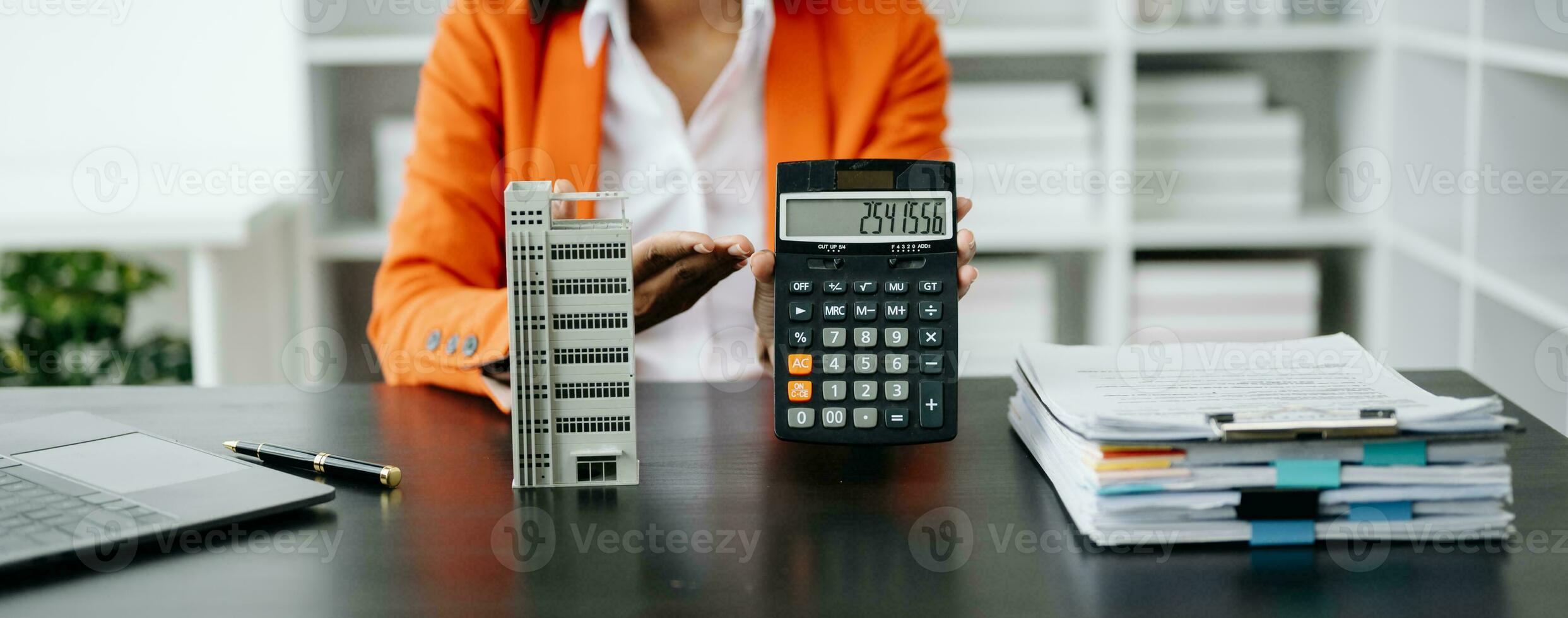 Real estate broker agent presenting and consult to customer to decision making sign insurance form agreement, home model, concerning mortgage loan offer photo