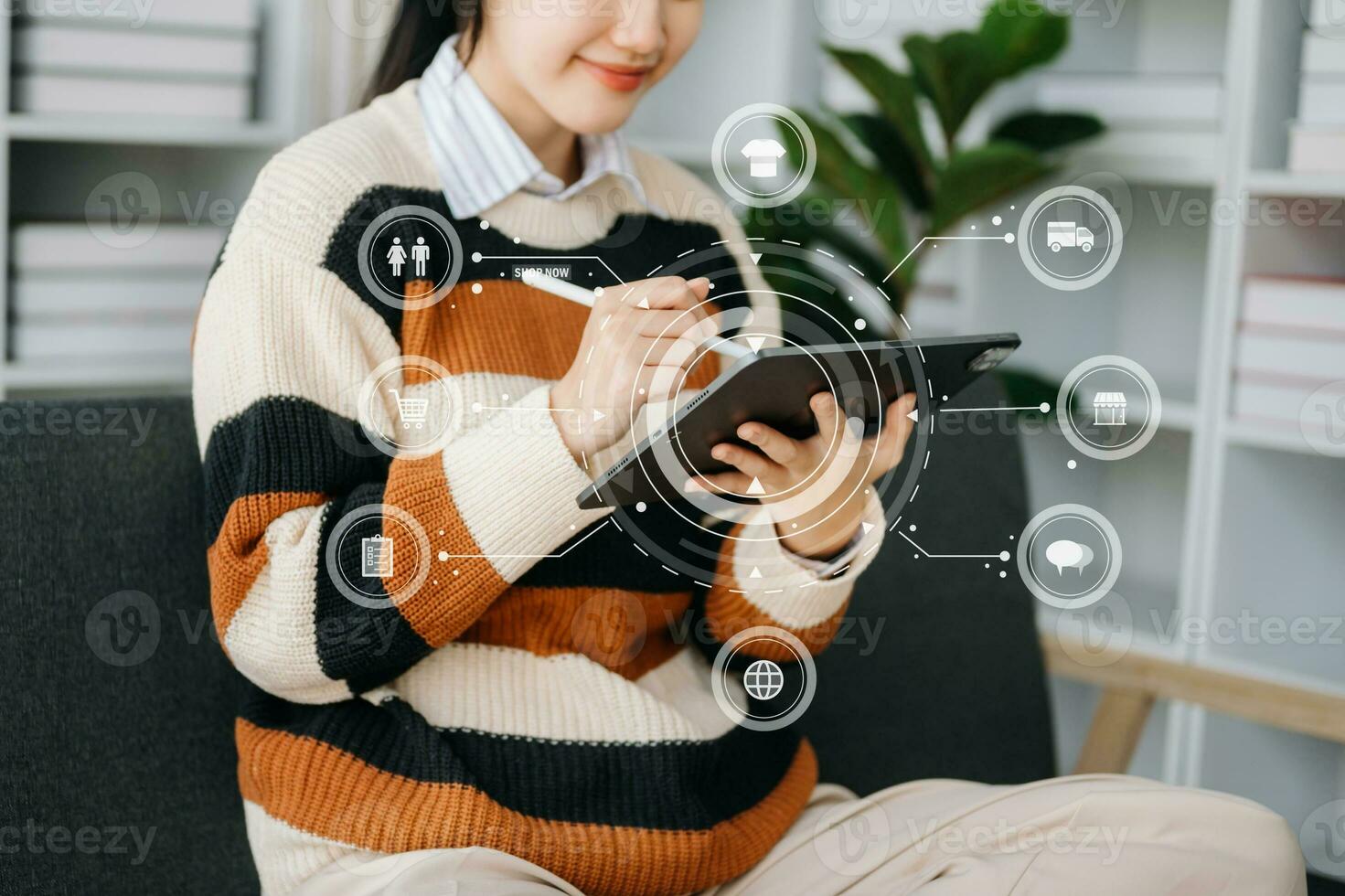 Woman hand using a laptop, smartphone and tablet and writing notebook at the office of her business online shopping. In home with virtual icon photo