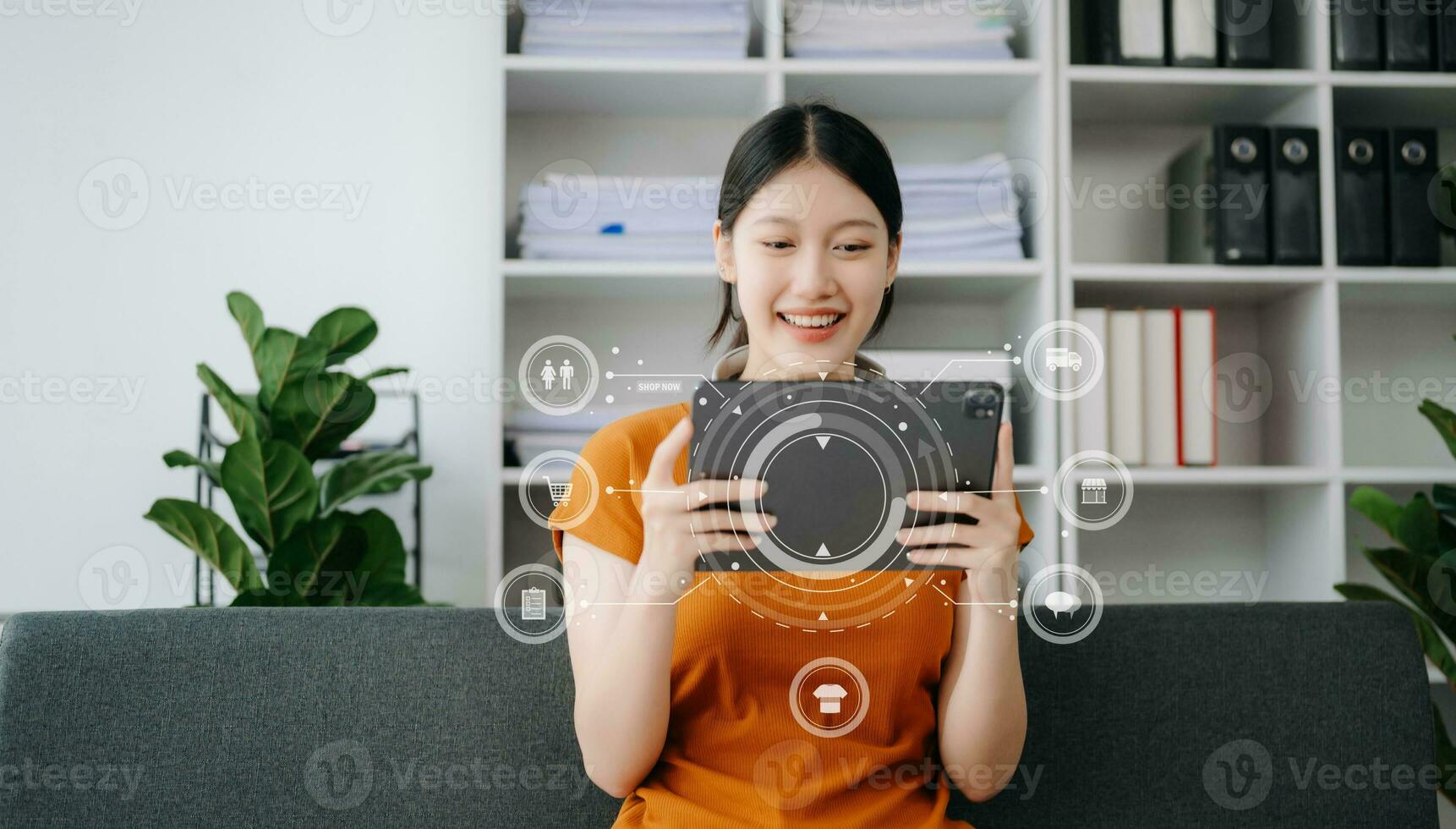 Woman using smart phone for mobile payments online shopping,omni channel,sitting on table,virtual icons graphics interface screen photo