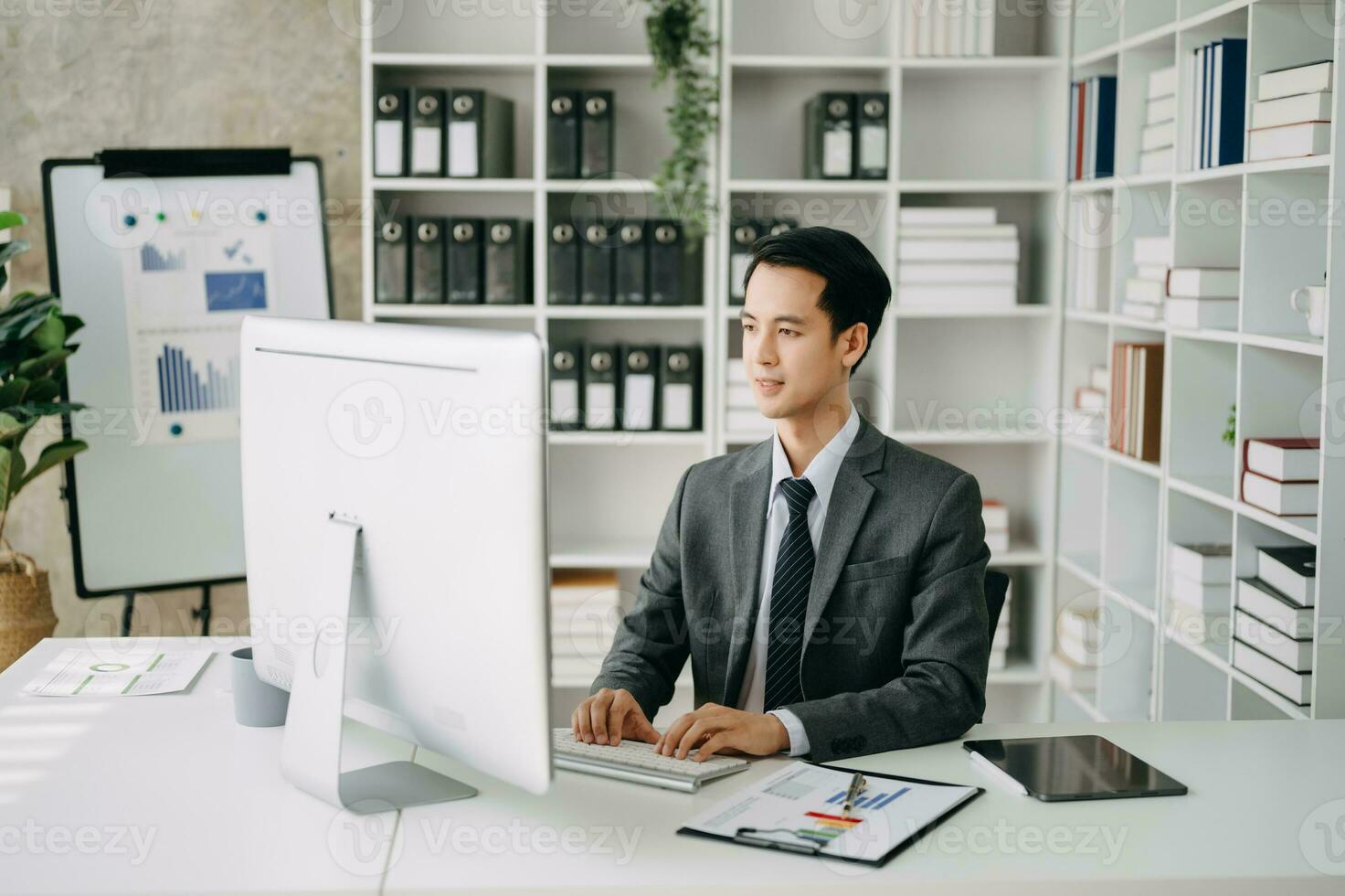 Young business man executive manager looking at laptop watching online webinar training or having virtual meeting video conference doing market research working in office. photo