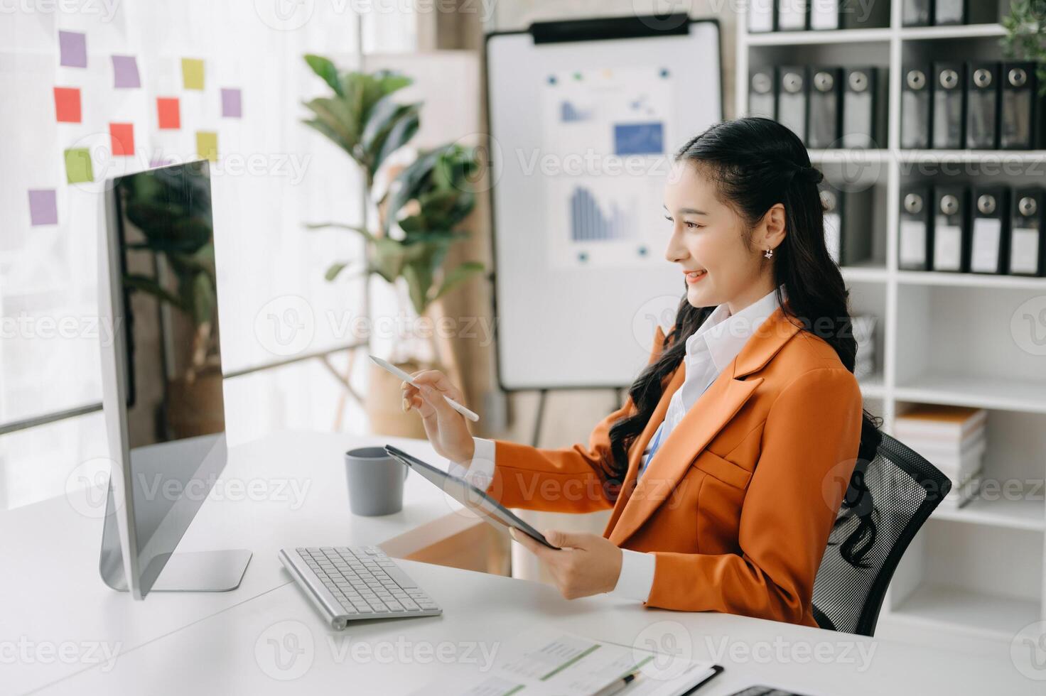 Business woman using tablet and laptop for doing math finance on an office desk, tax, report, accounting, statistics, and analytical research concept in office photo