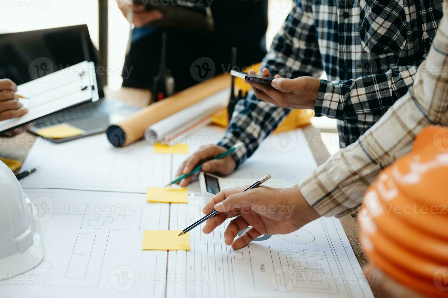 Engineer desk with object paper and tablet with blurry engineer teamwork hardworking to consults about their building project. photo