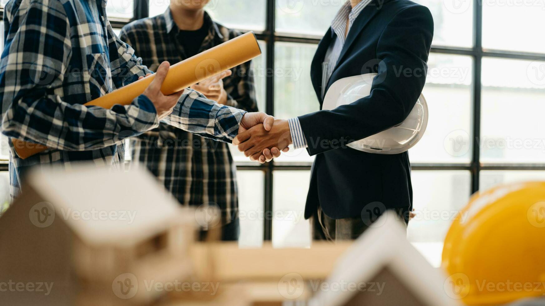 Engineer teams meeting working together wear worker helmets hardhat on construction site in modern city.Asian industry professional team in office photo