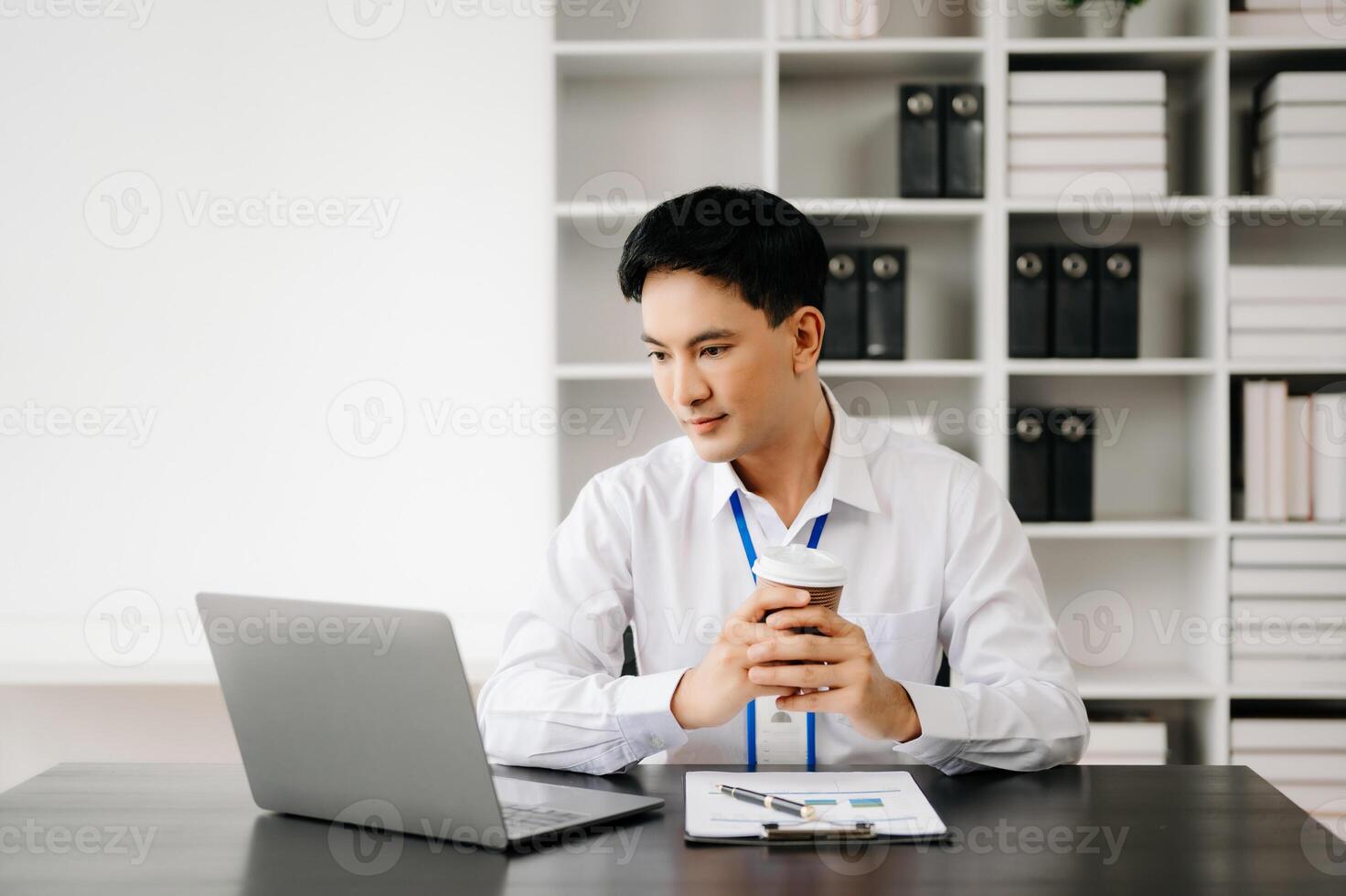 Businessman using tablet and laptop for doing math finance on an office desk, tax, report, accounting, statistics, and analytical research concept in office photo