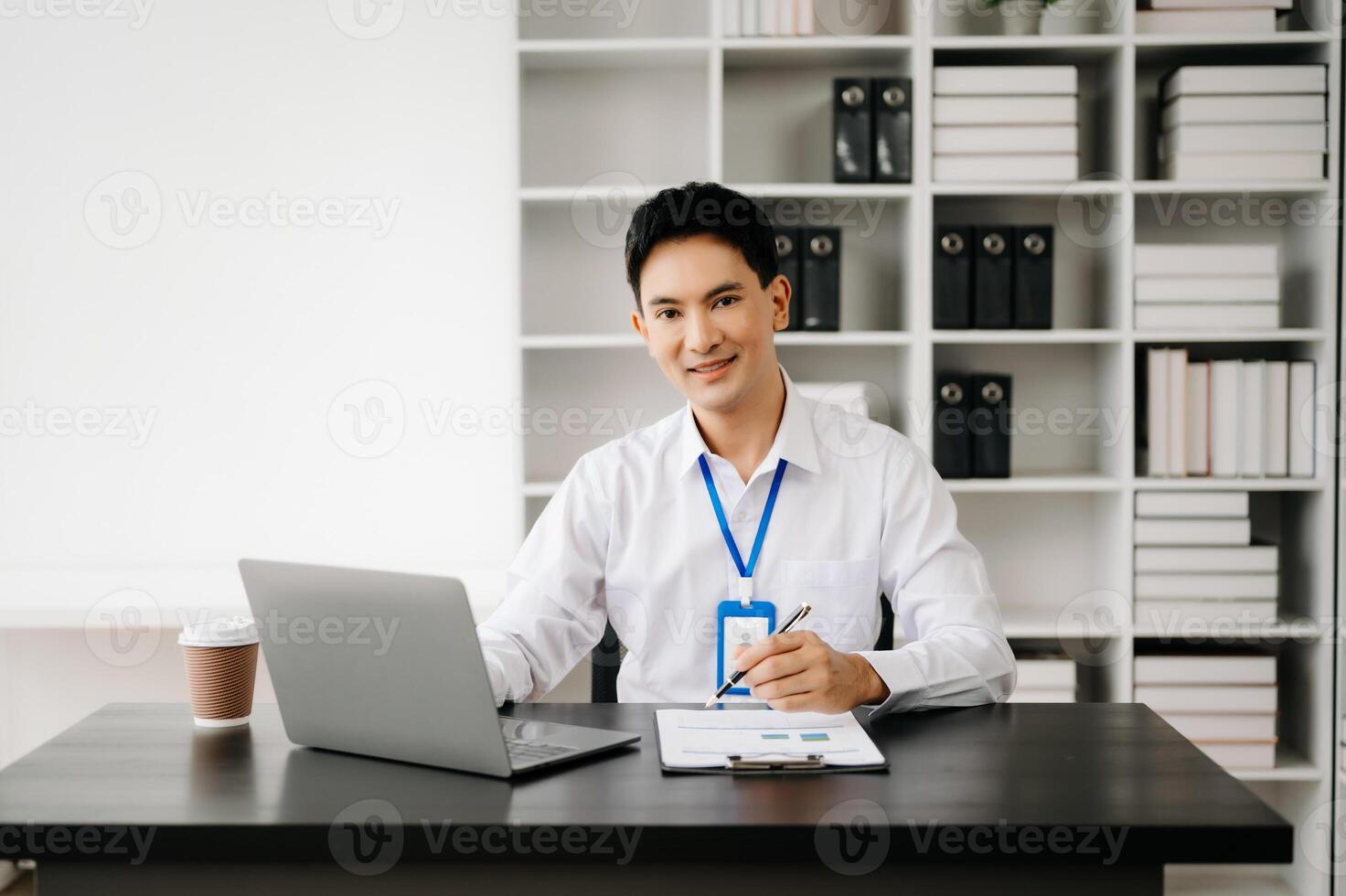 Businessman using tablet and laptop for doing math finance on an office desk, tax, report, accounting, statistics, and analytical research concept in office photo