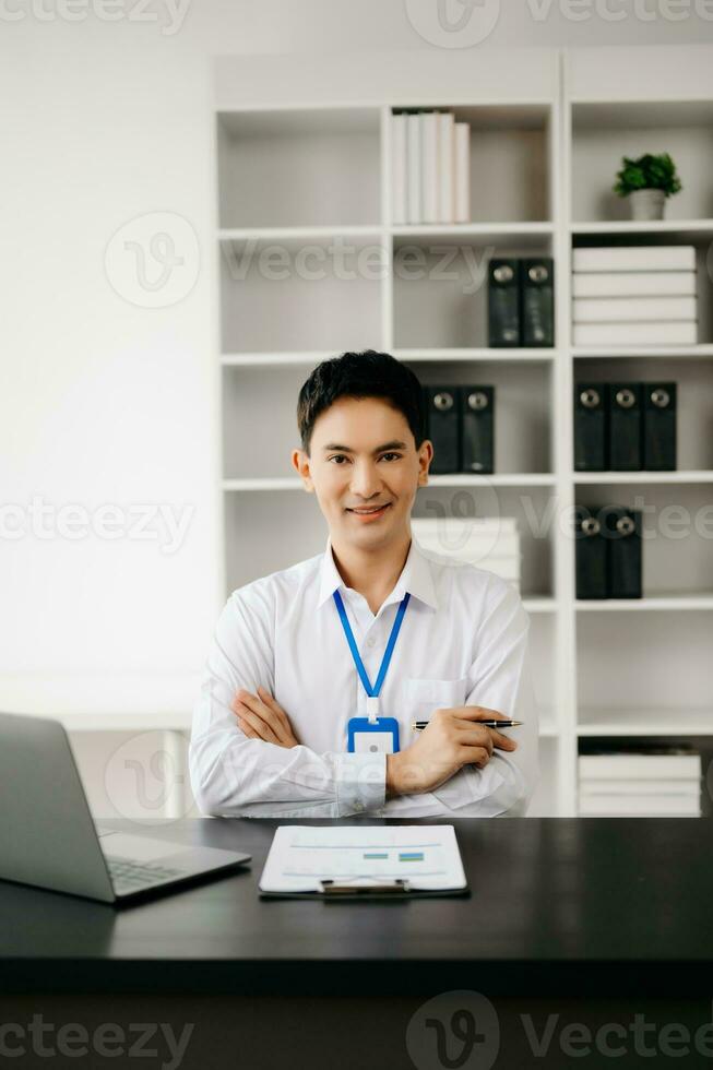 Businessman using tablet and laptop for doing math finance on an office desk, tax, report, accounting, statistics, and analytical research concept in office photo