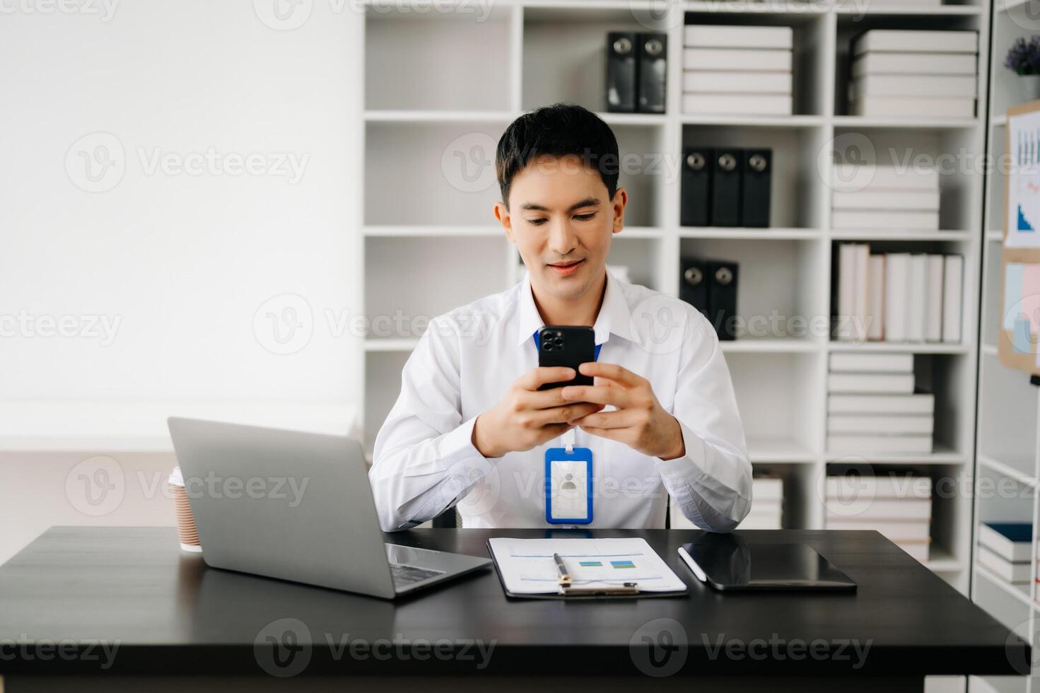 Businessman using tablet and laptop for doing math finance on an office desk, tax, report, accounting, statistics, and analytical research concept in office photo