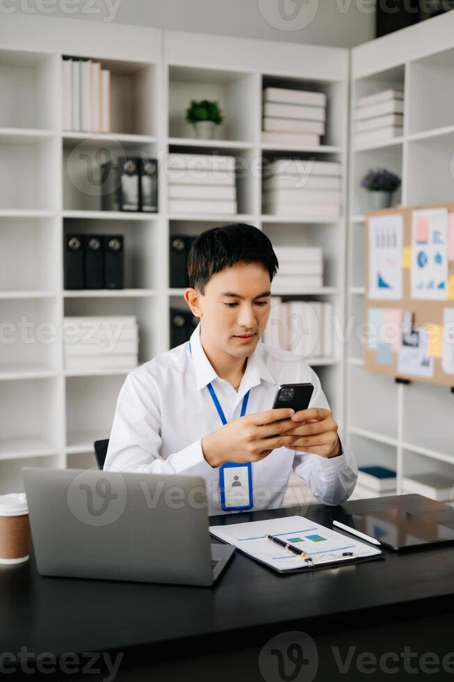 Businessman using tablet and laptop for doing math finance on an office desk, tax, report, accounting, statistics, and analytical research concept in office photo