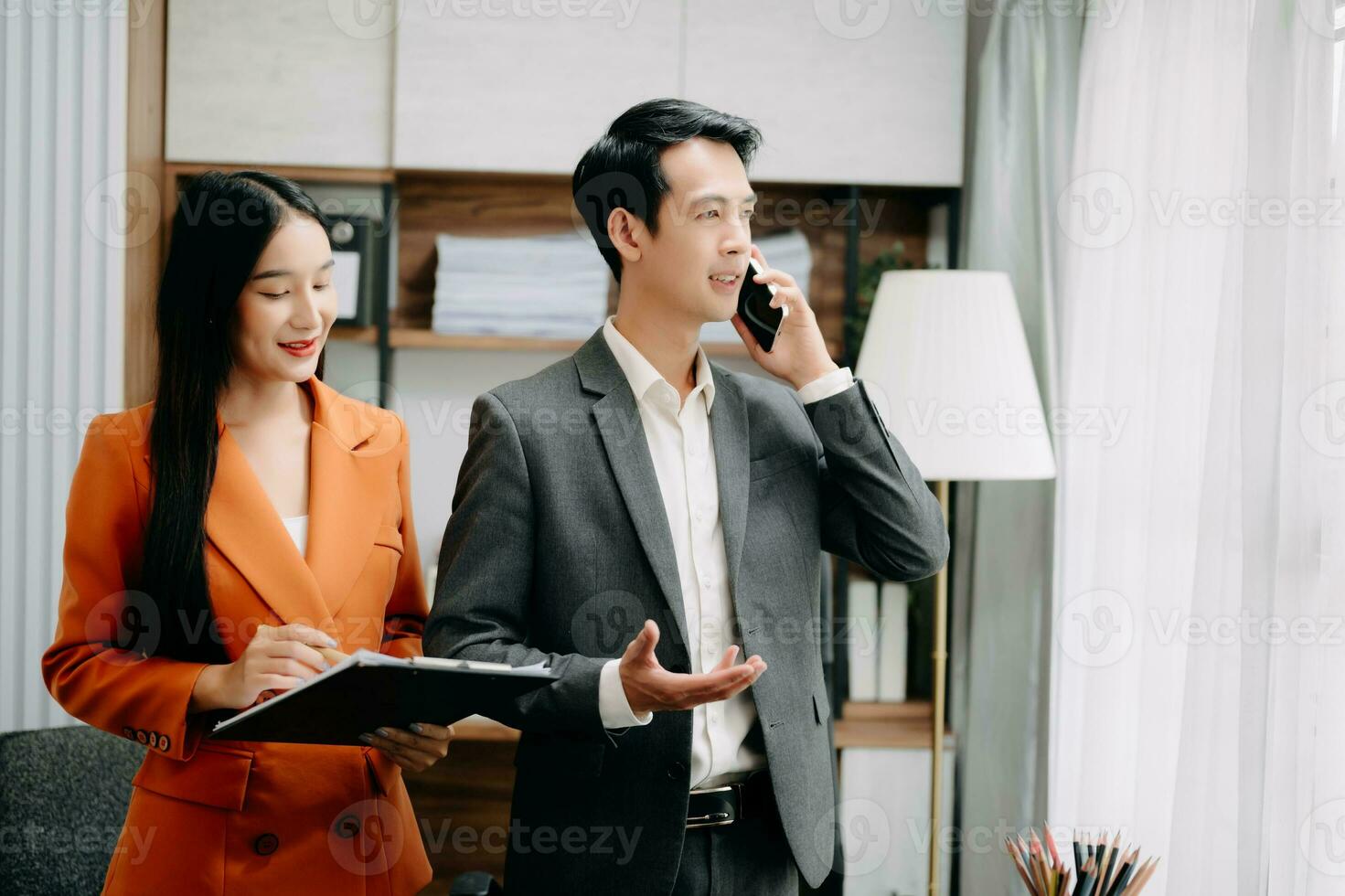 Two Asian businesswoman discuss investment project working and planning strategy with tablet laptop computer in  office. photo