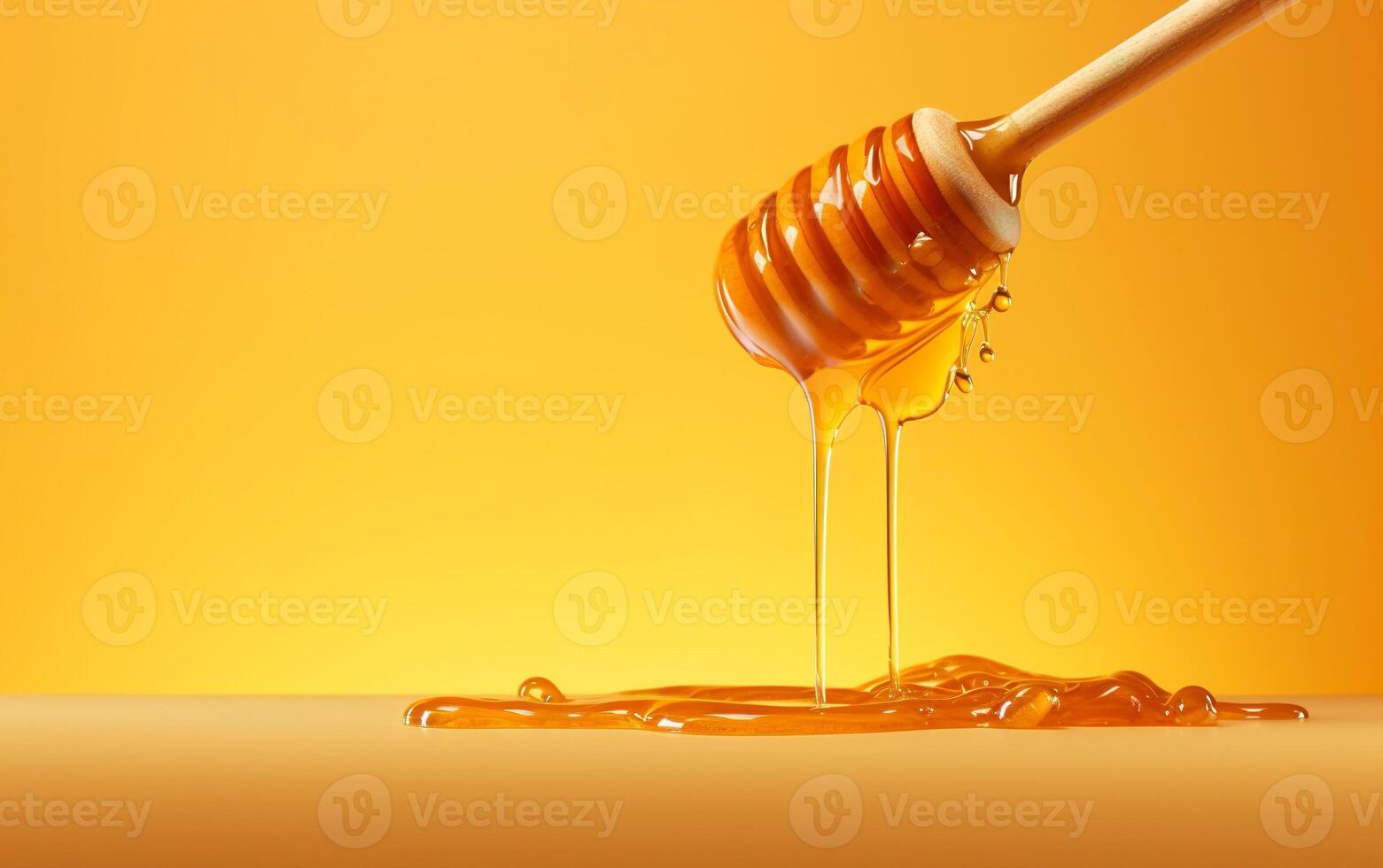 Honey dripping from wooden spoon over yellow background. Sweet bee product concept. . photo