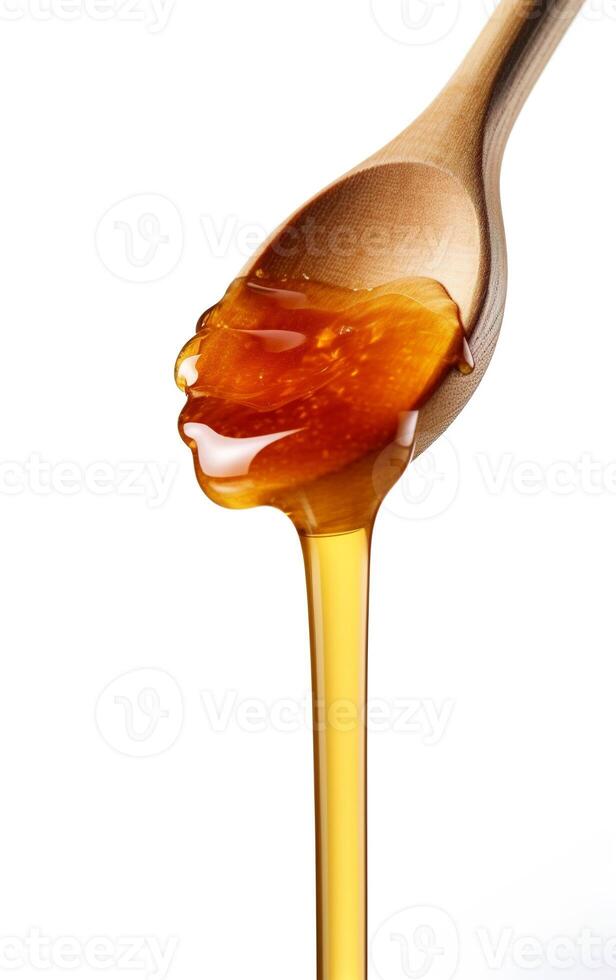 Honey dripping from wooden spoon over white background. Sweet bee product concept. . photo