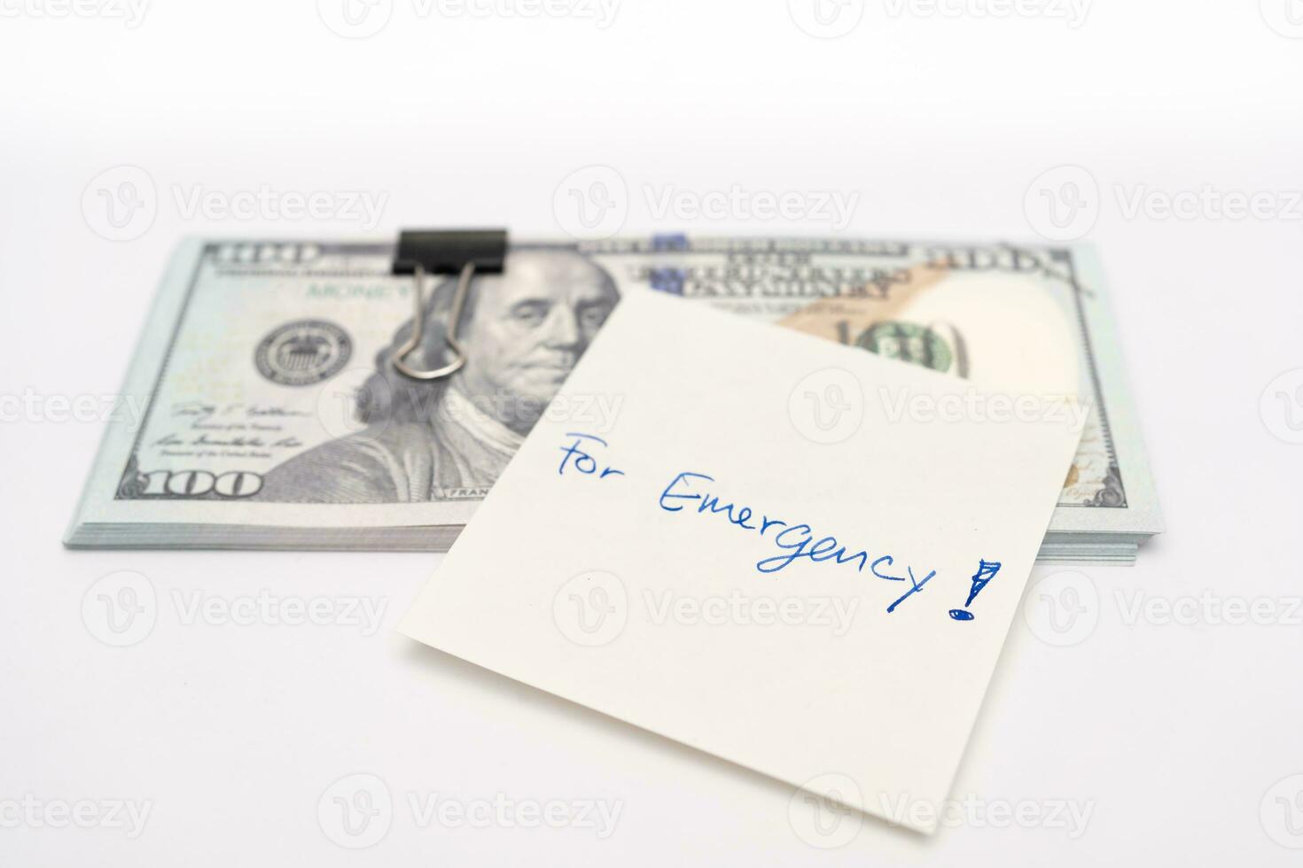 Dollars cash money and paper note with text written FOR EMERGENCY. concept of financial planning saving money goal on purpose of rainy day. photo