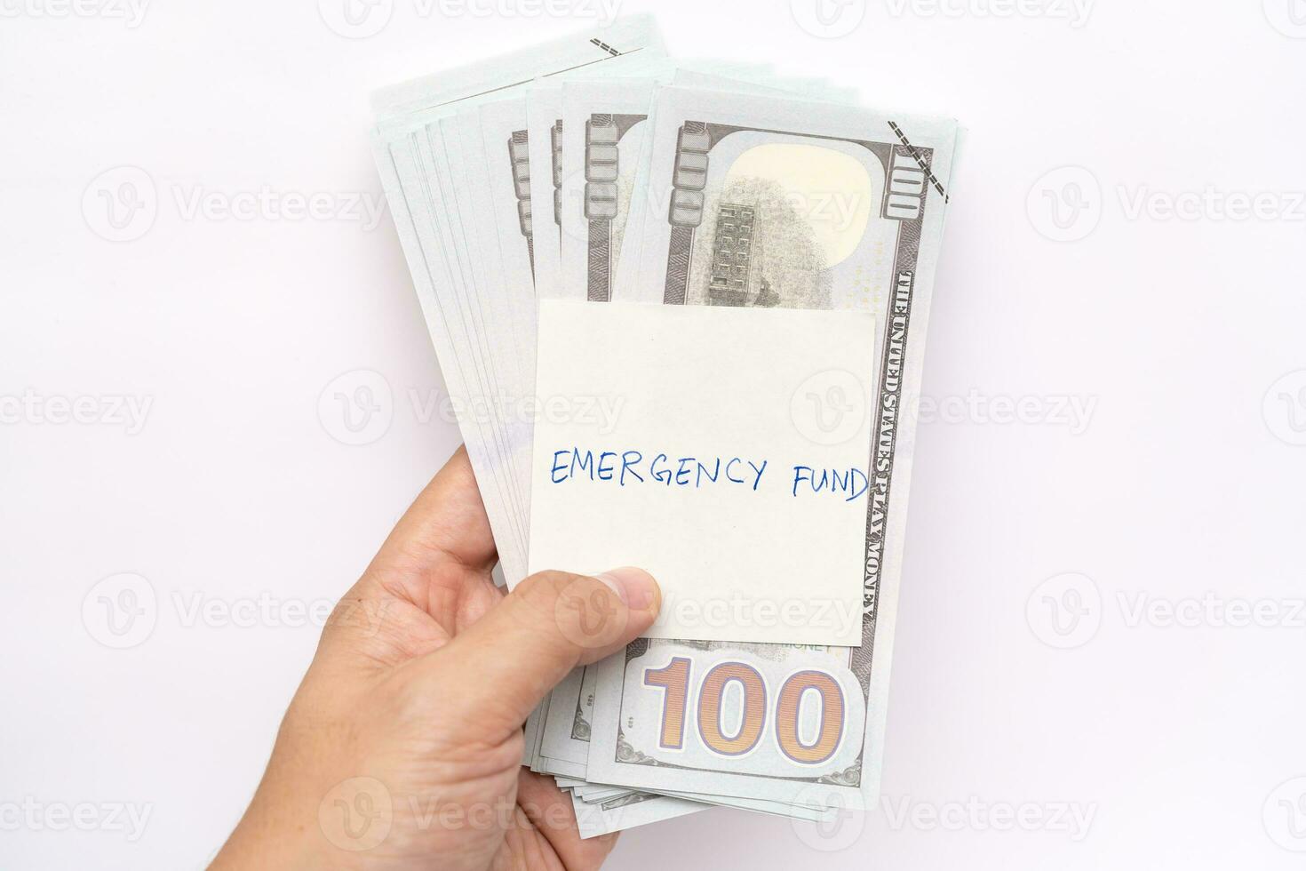 US dollars in paper clip on white background with note written EMERGENCY FUND. Concept of money saving goal. Financial planning saving money for purpose of rainy day crisis. photo