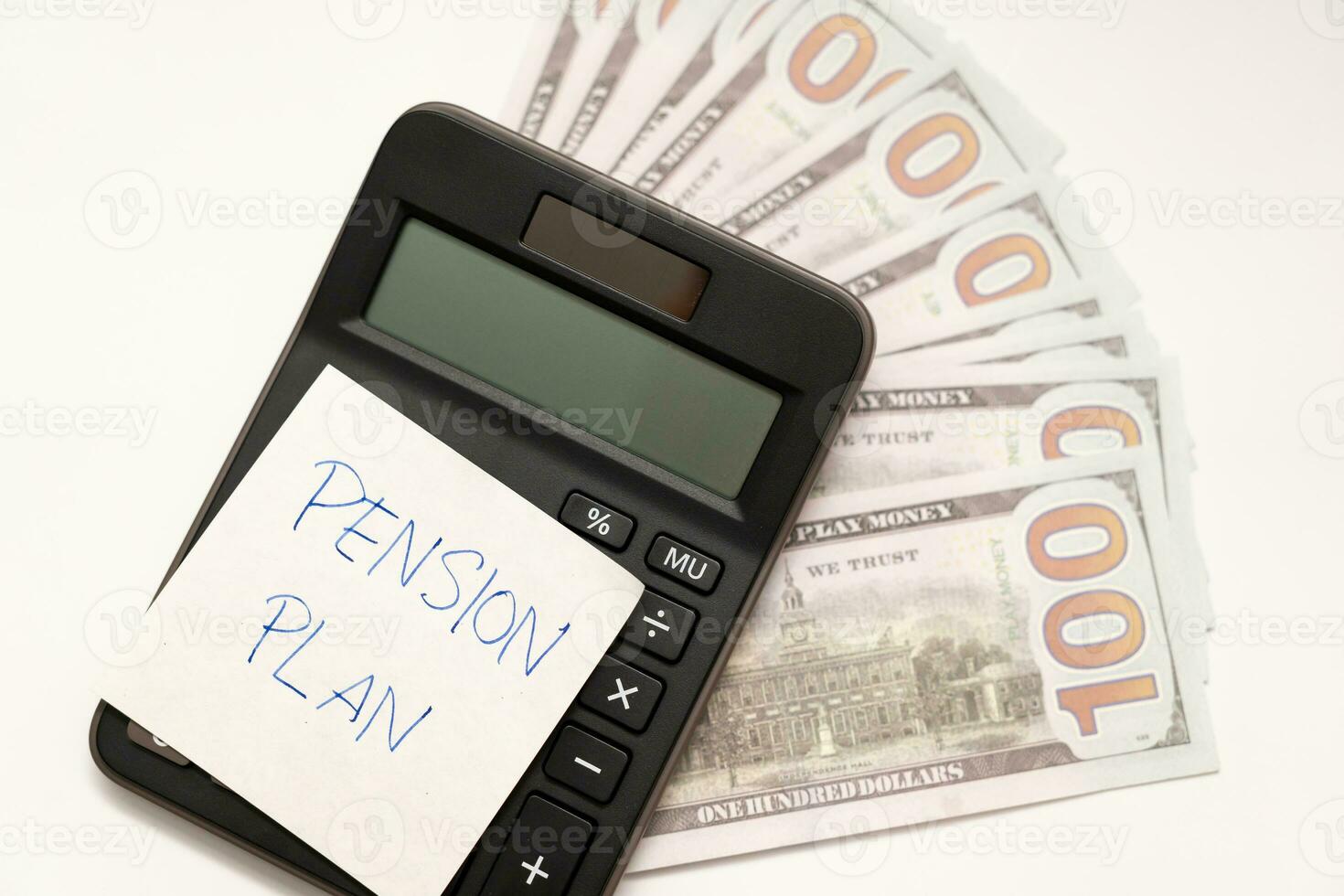 Paper note with phrase Pension Plan, dollar banknotes, calculator. Retirement concept. Retirement saving and pension planning. photo