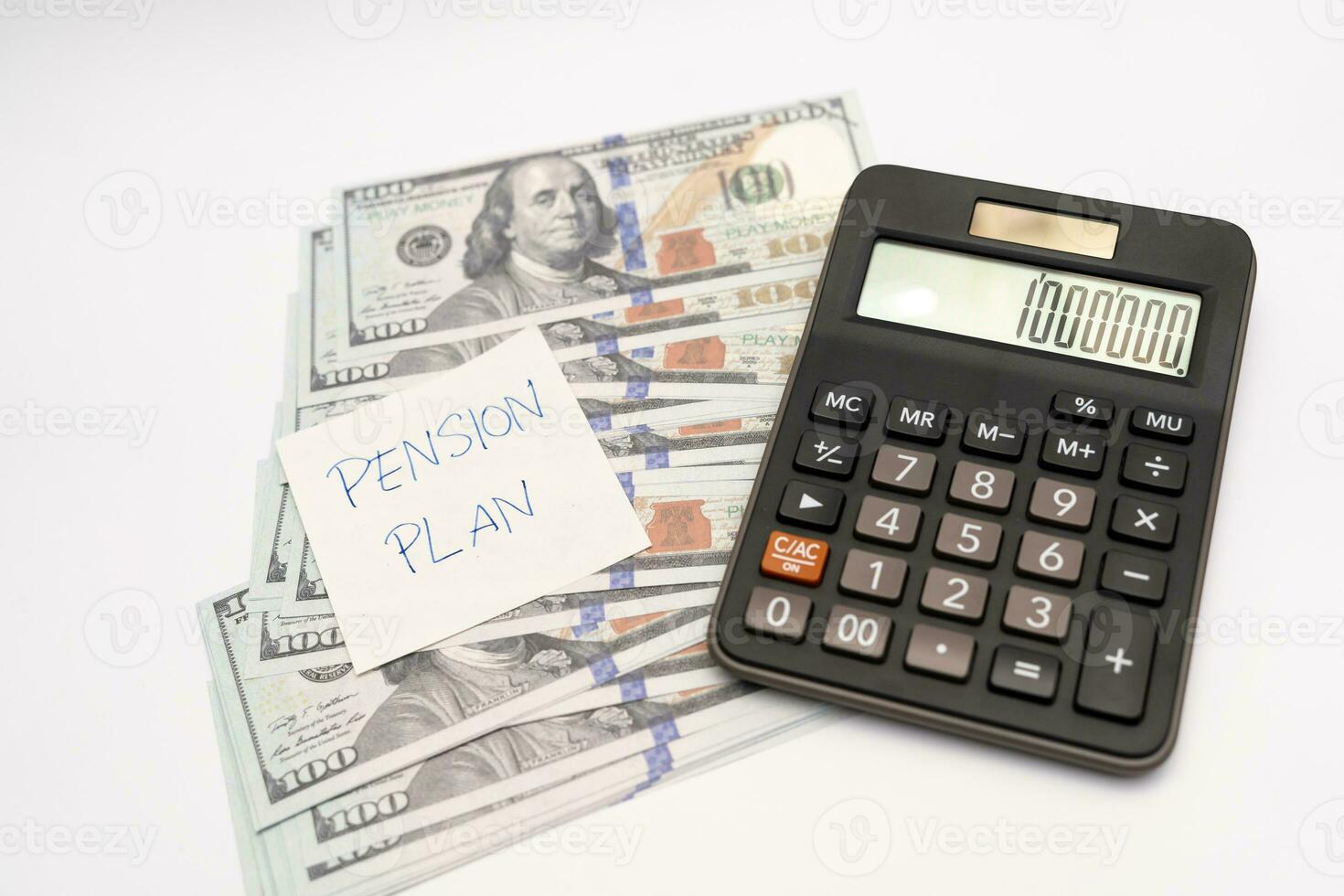 Paper note with phrase Pension Plan, dollar banknotes, calculator. Retirement concept. Retirement saving and pension planning. photo