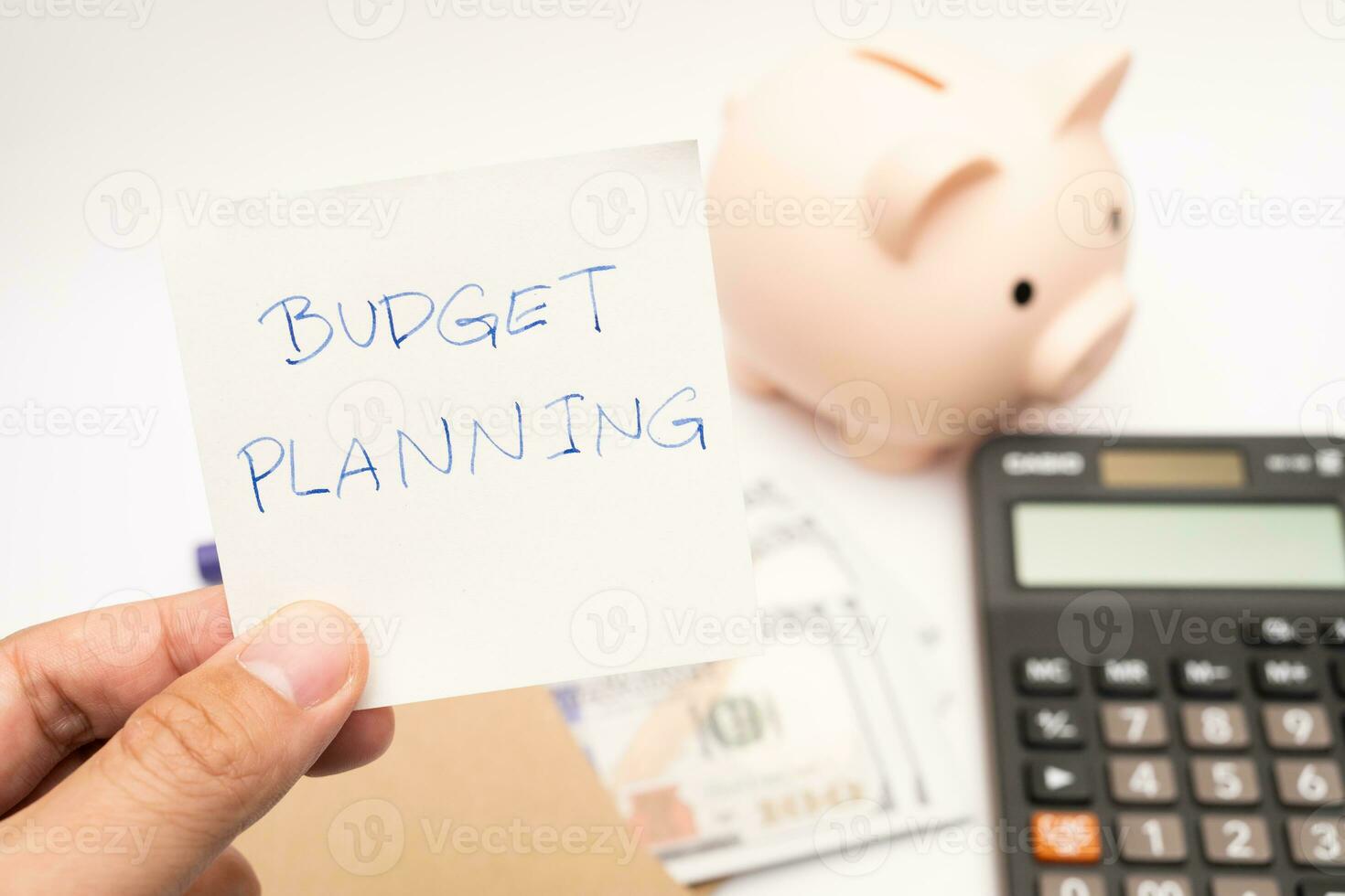 Money budget planning. Piggy bank with calculator and notebooks on white background, financial goal concept. photo