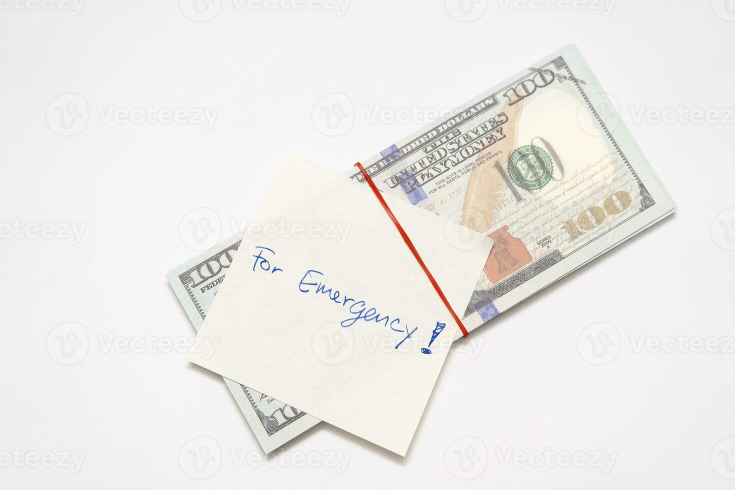 Dollars cash money and paper note with text written FOR EMERGENCY. concept of financial planning saving money goal on purpose of rainy day. photo