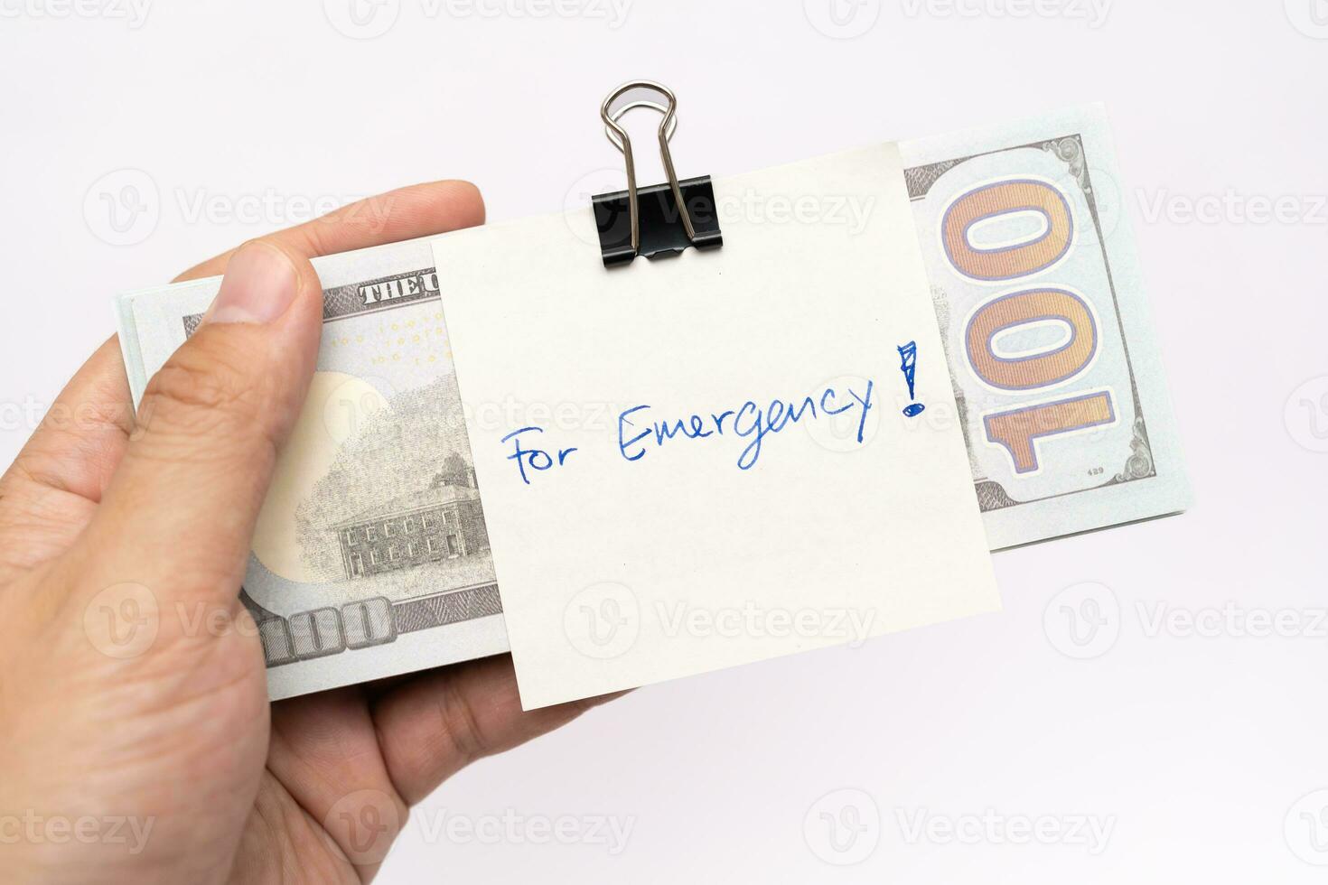 Dollars cash money and paper note with text written FOR EMERGENCY. concept of financial planning saving money goal on purpose of rainy day. photo