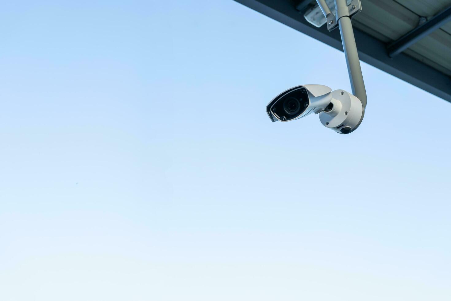 CCTV surveillance security camera video equipment on pole outdoor building safety system area control and copy space. Smart camera theft protection. photo