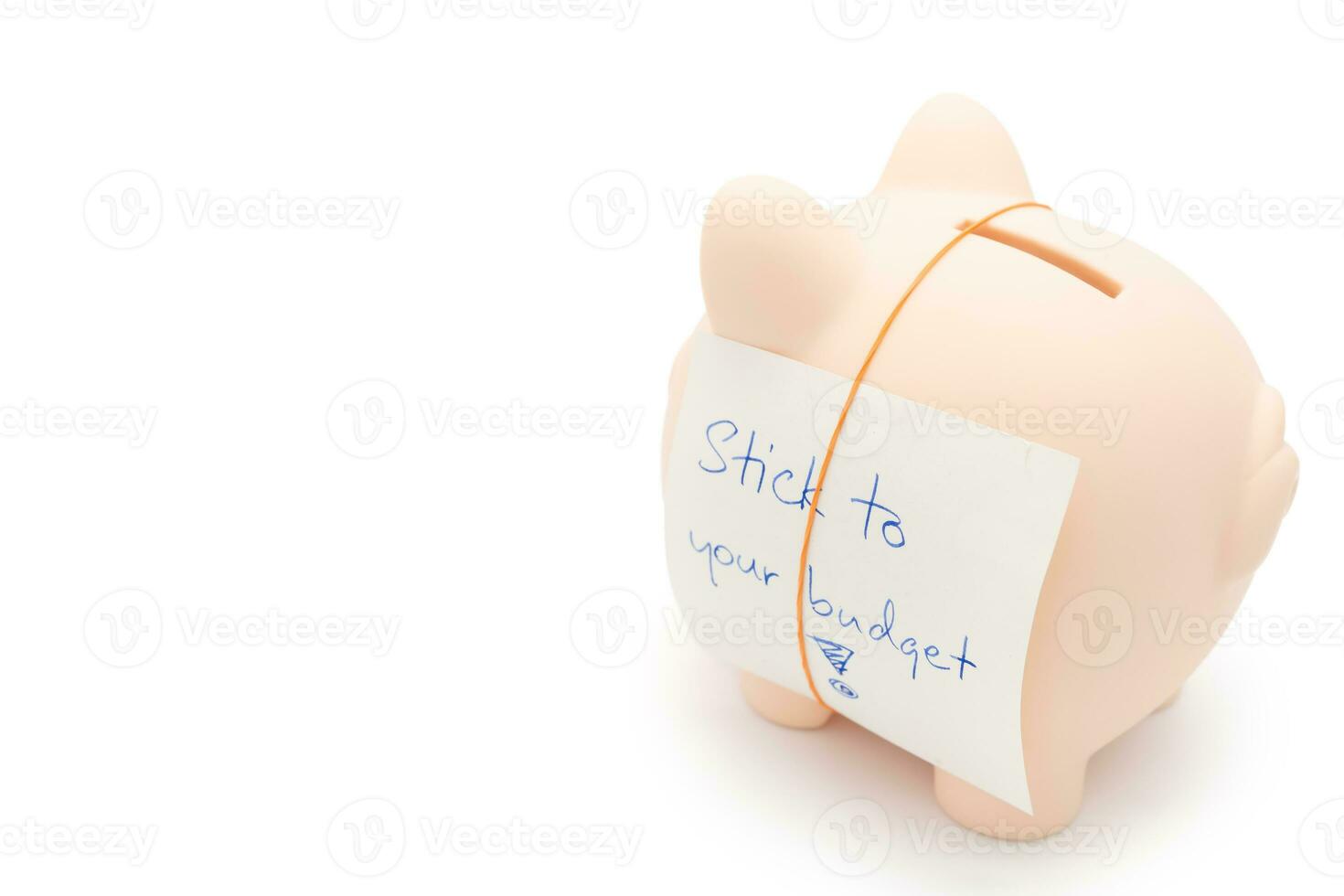 Text written note STICK TO YOUR BUDGET and Piggy bank. concept of financial planning to save money by spending less. Finance and business concept. isolated on white background. photo