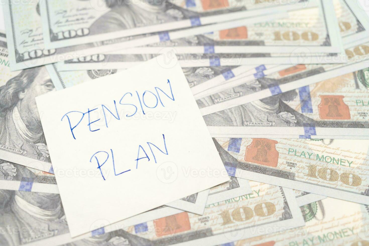 Paper note with phrase Pension Plan, dollar banknotes. Retirement concept. Retirement saving and pension planning photo