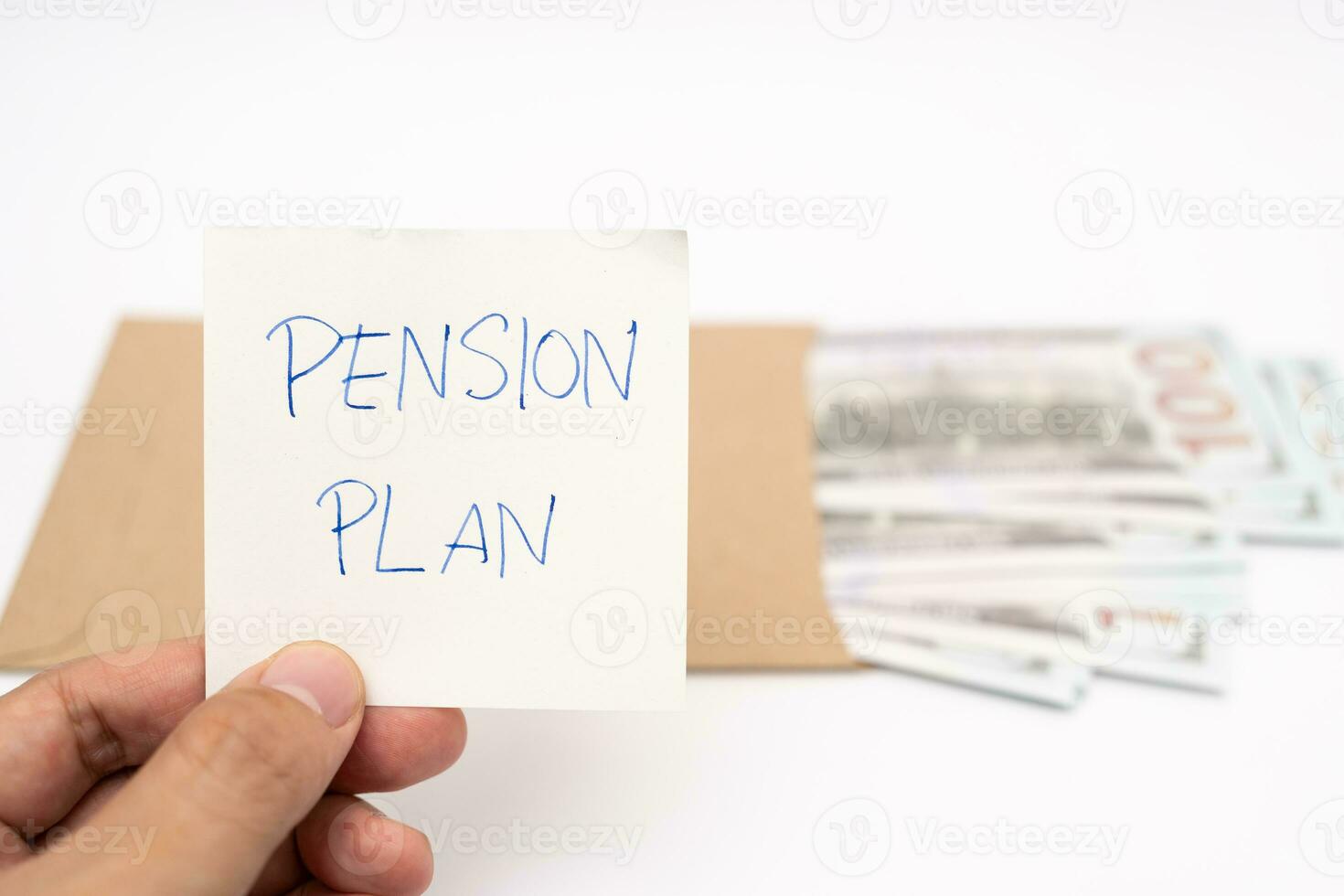 Dollars cash money in craft paper envelope and paper note with text written PENSION PLAN. Investments Concept. Elderly Spouses Saving Money, Pension Plan. Retirement concept. photo