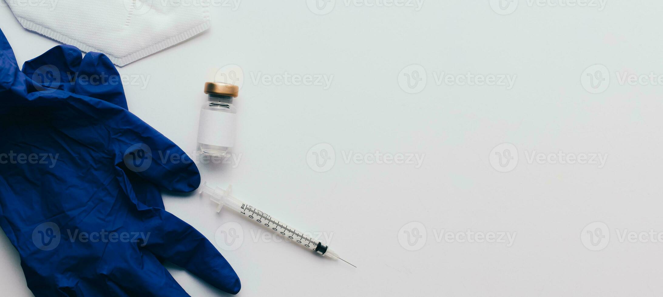 Web banner of vaccine in vial, syringe, face mask and gloves over white background and copy space. Medical concept. Insurance, laboratory, subcutaneous injection. Disease treatment immunization. photo