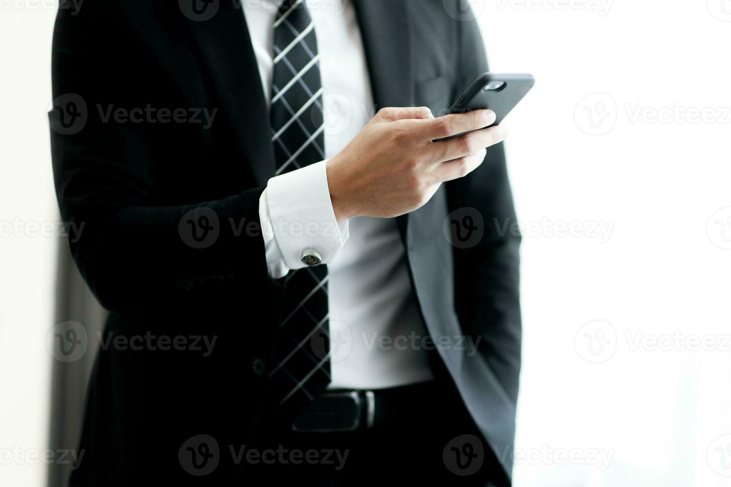 Businessman using smartphones in the company for contact work project. Concept of business people using technology. photo