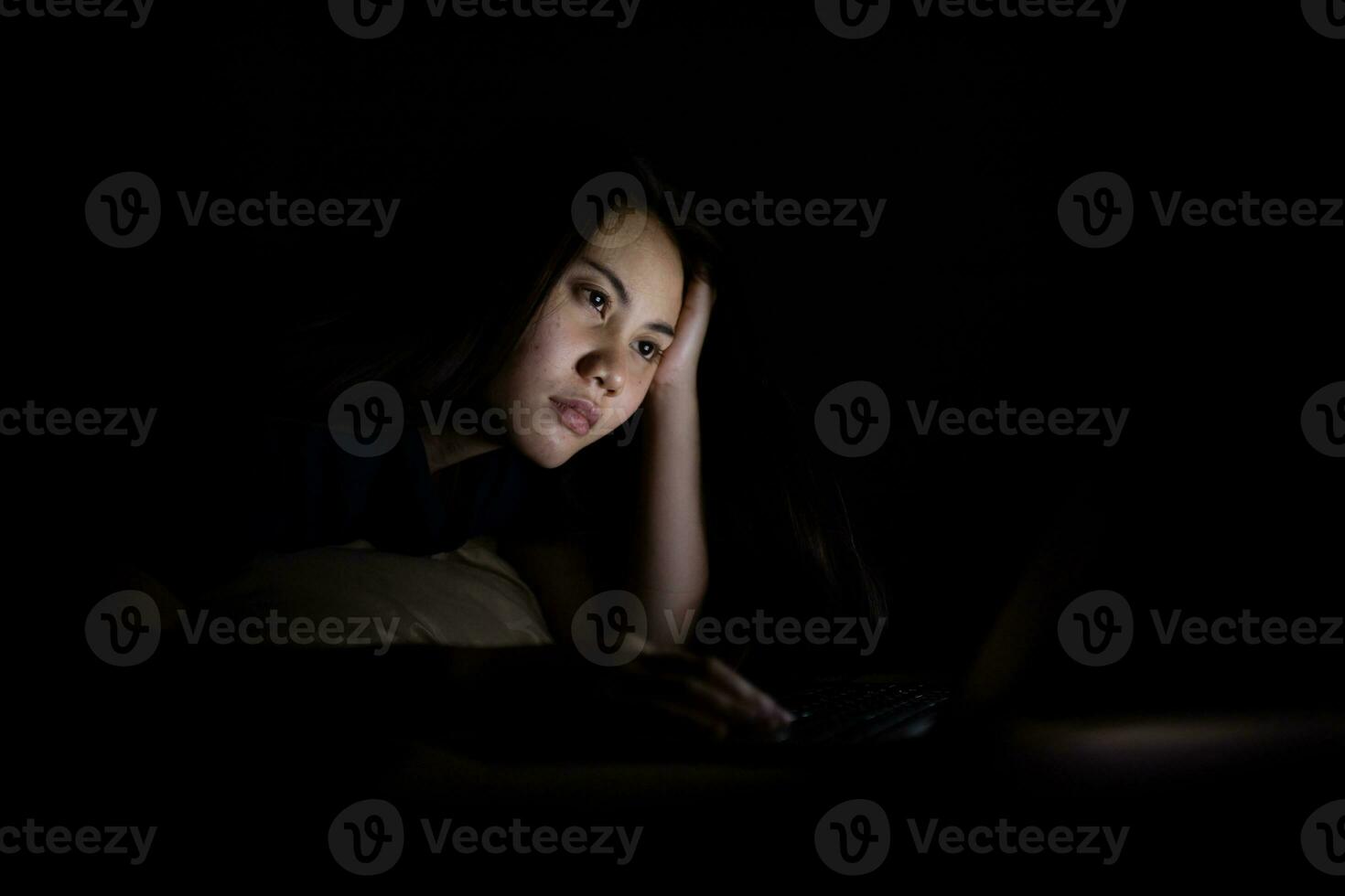 Young asian women work late at night stressed out. Tired and exhausted from working on computer laptop in the bedroom. photo