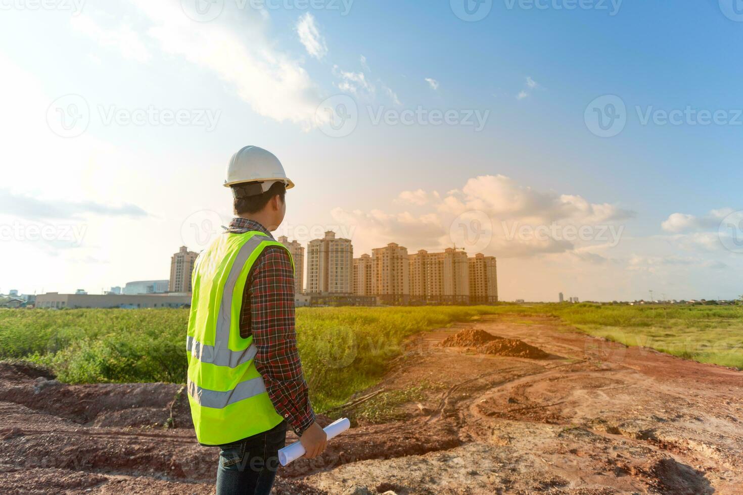 Engineer male working or checking at construction building site photo