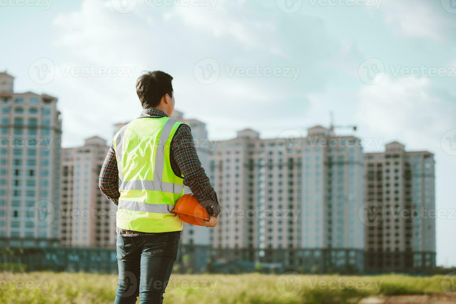 Engineer male working or checking at construction building site photo